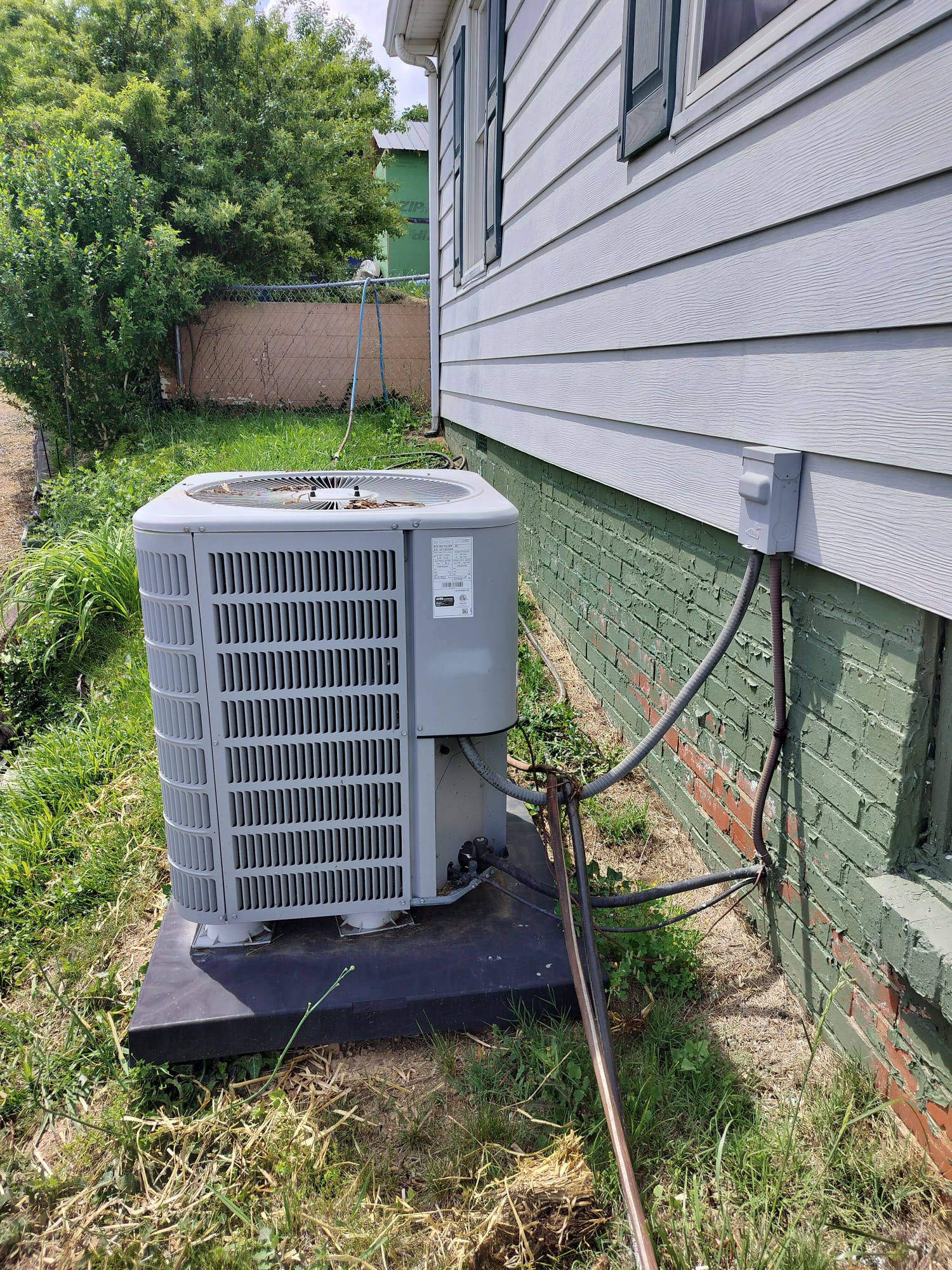 Newly installed outdoor HVAC unit mounted on a robust platform