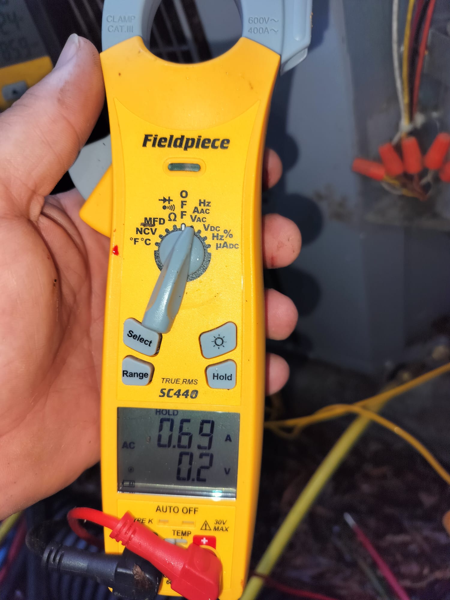 Technician Using Digital Clamp Meter