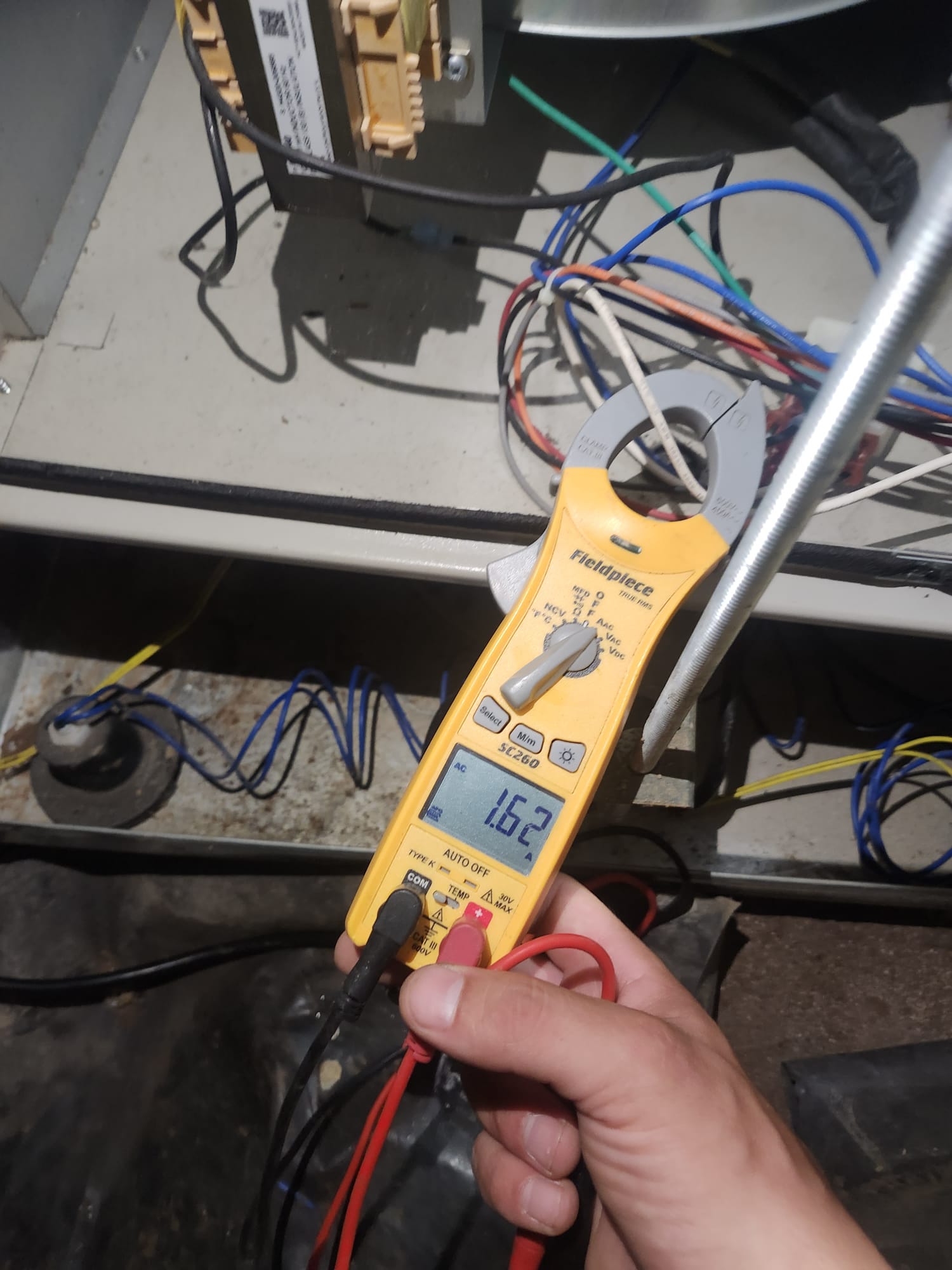 Technician Using Clamp Meter