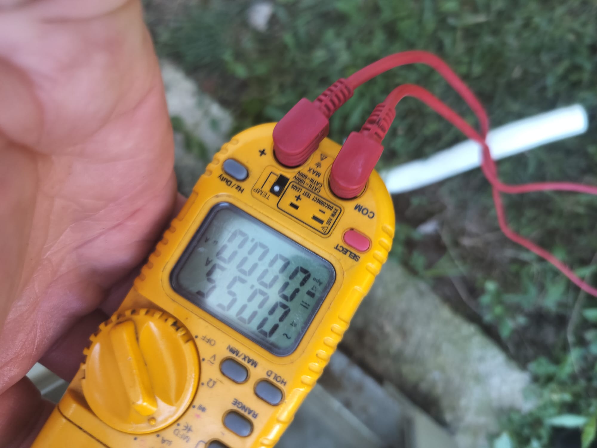 Technician using a digital multimeter for diagnostic purposes