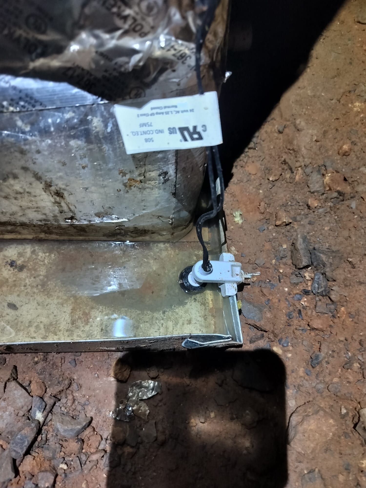 Condensate drain pan showing standing water before maintenance