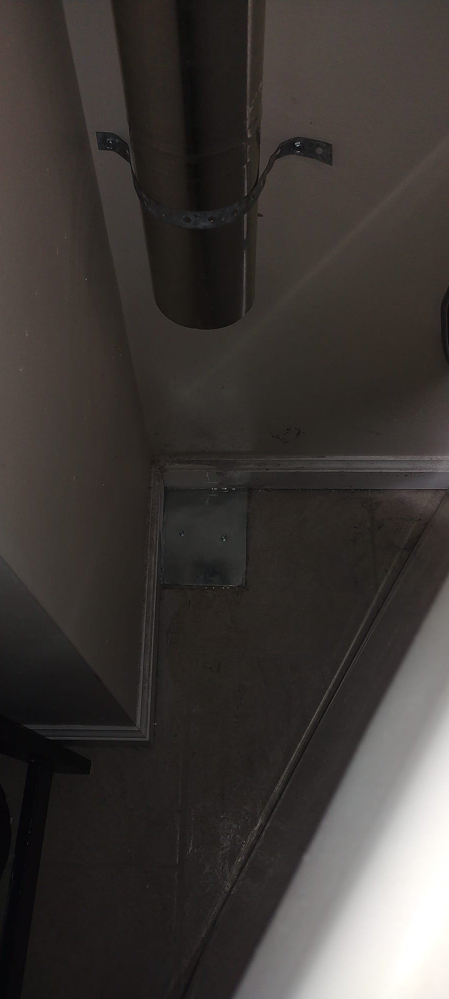 New metal plate covering old floor vent opening