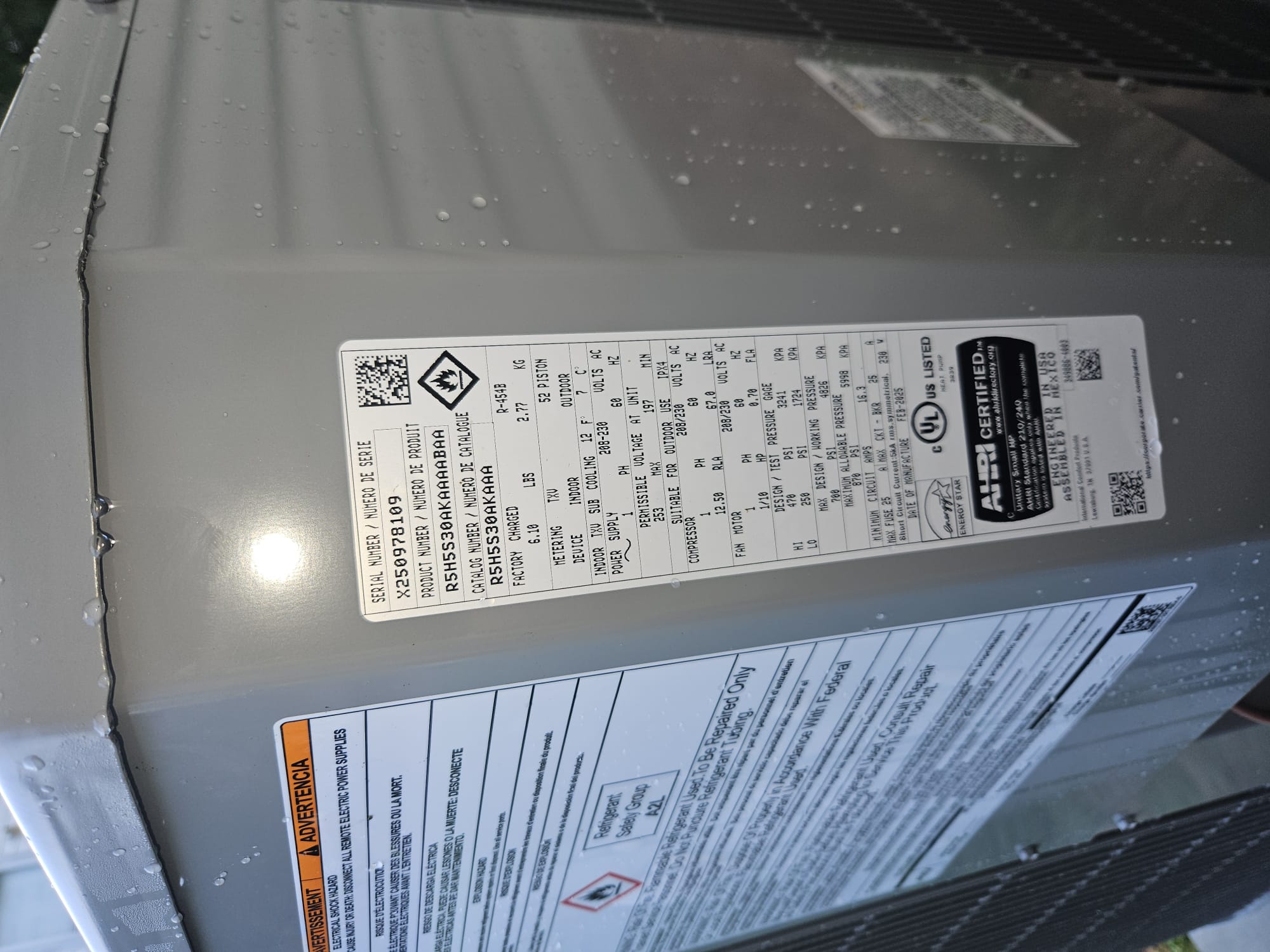 New outdoor HVAC condenser unit with water droplets
