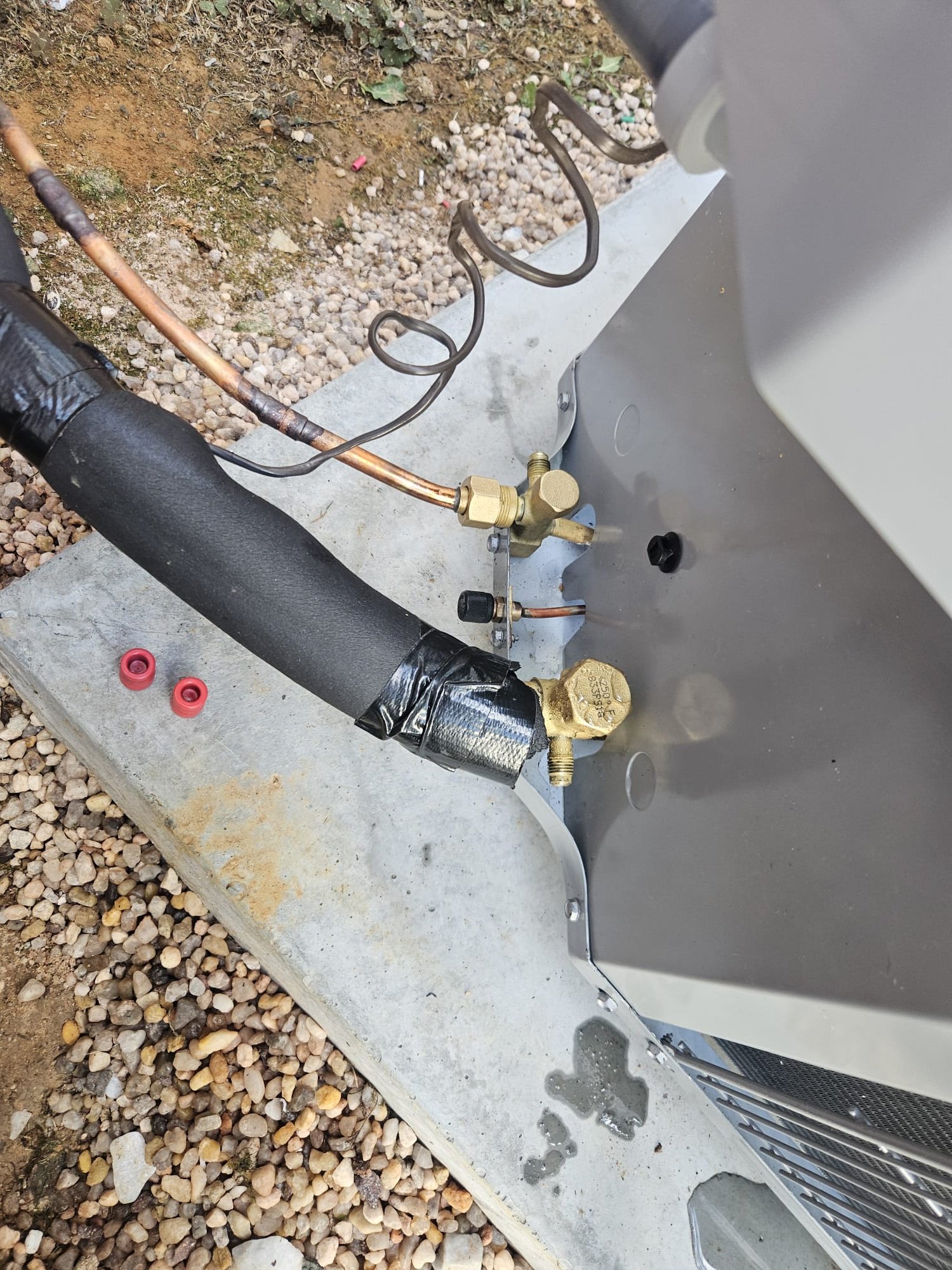 New refrigerant line connections on outdoor unit.