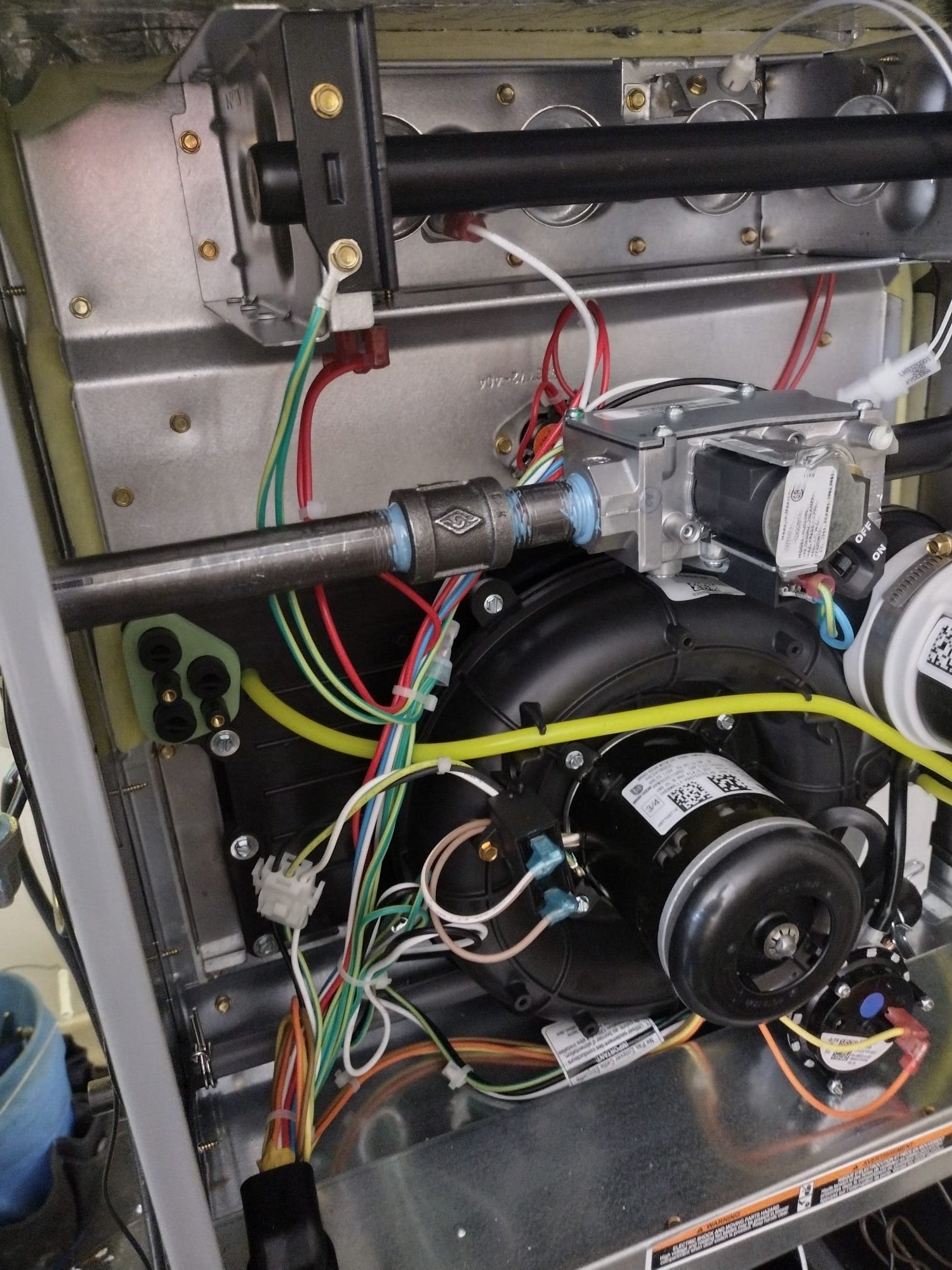 Clean internal view of the new furnace components, with organized wiring and blower motor.