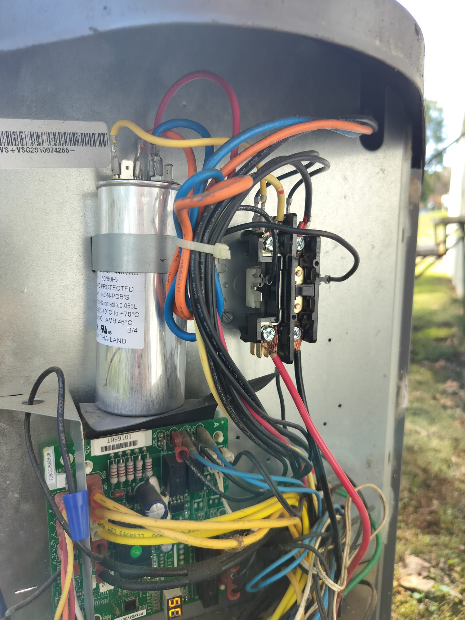 Newly installed capacitor and contactor inside the unit