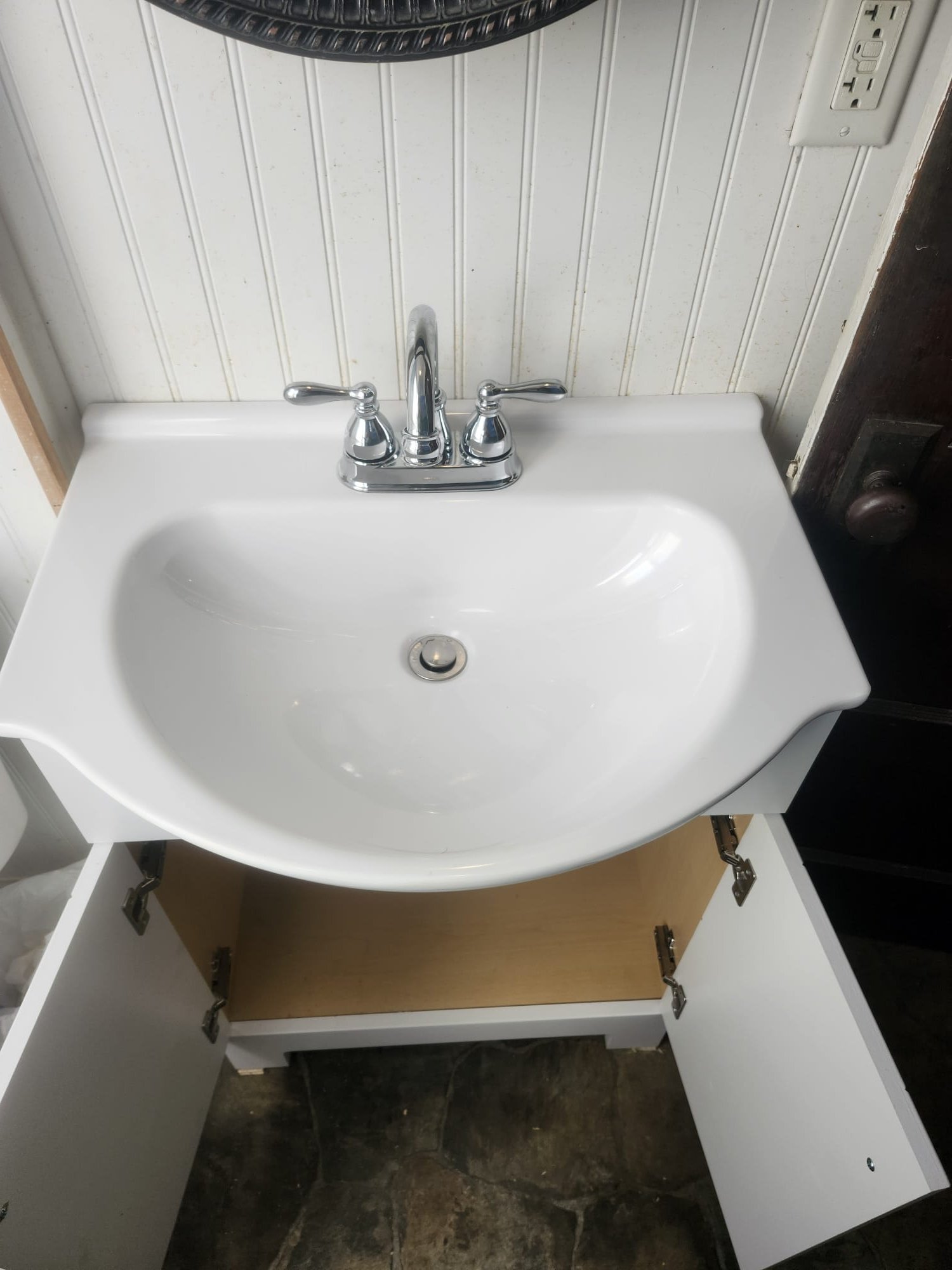 Newly installed bathroom sink and vanity unit, showcasing a clean finish