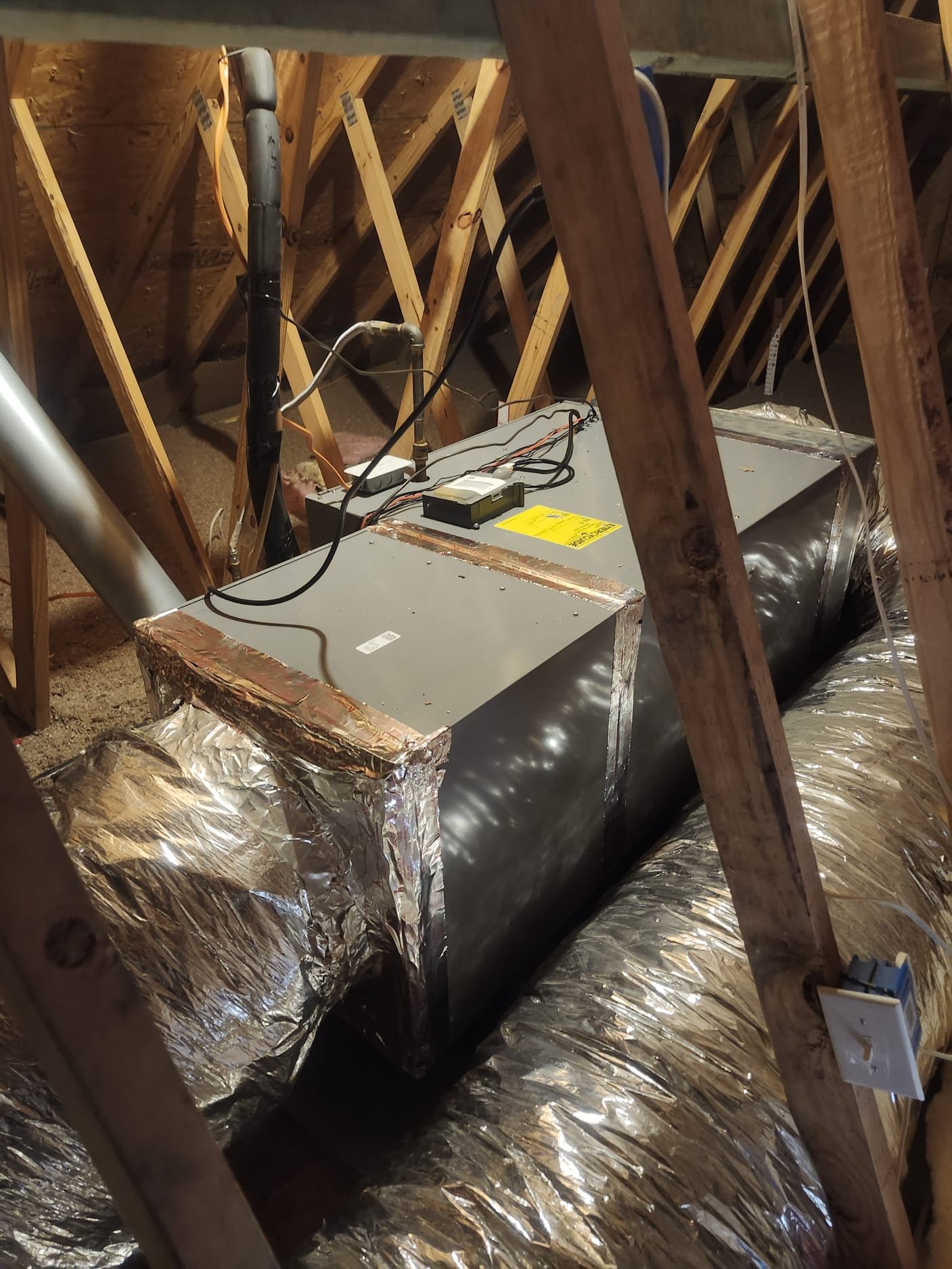 A well-installed air handler unit with sealed connections and clear labeling, highlighting professional installation standards.