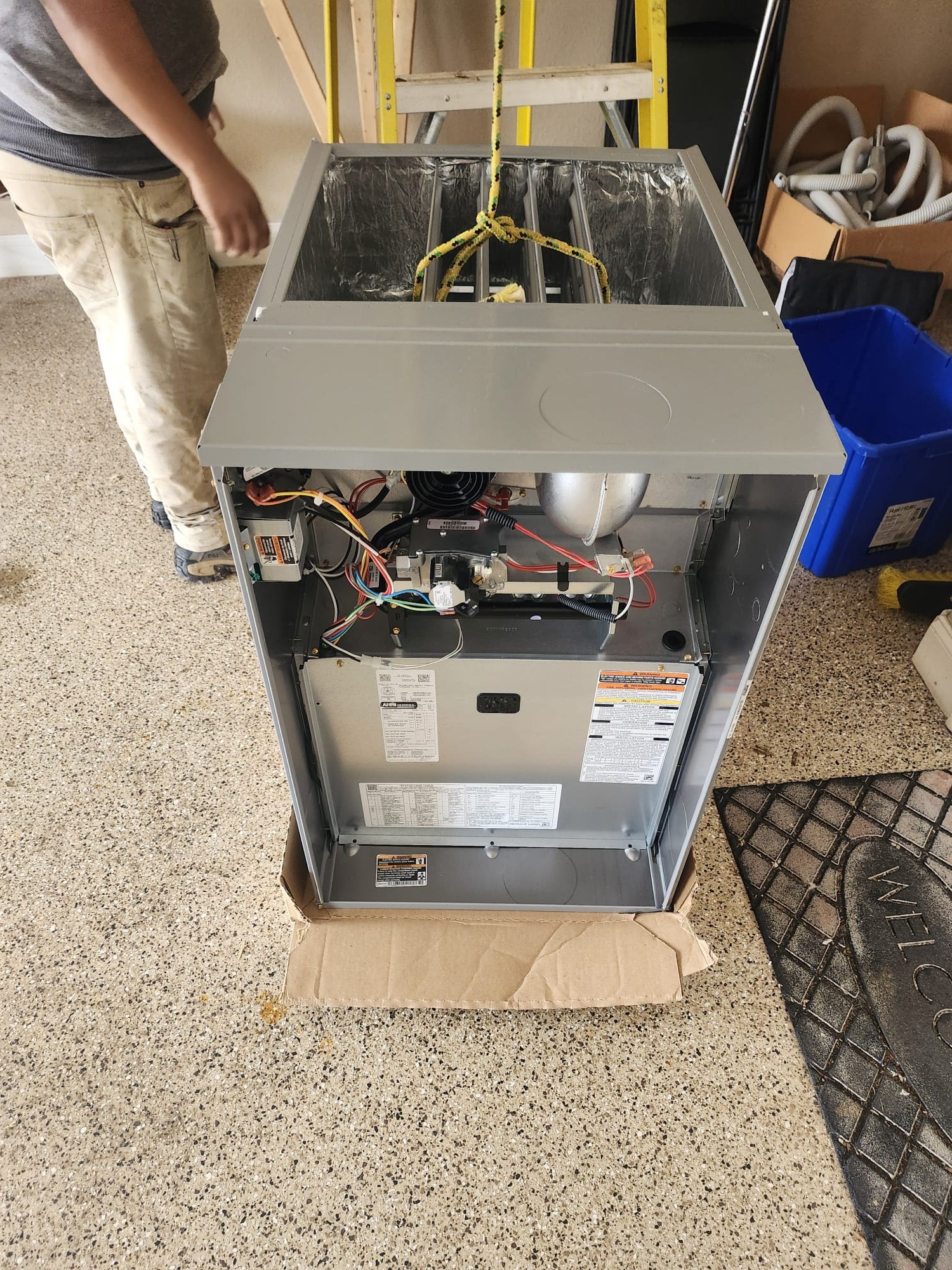 The newly unboxed furnace awaiting installation, demonstrating careful handling and setup by the HEP technician.