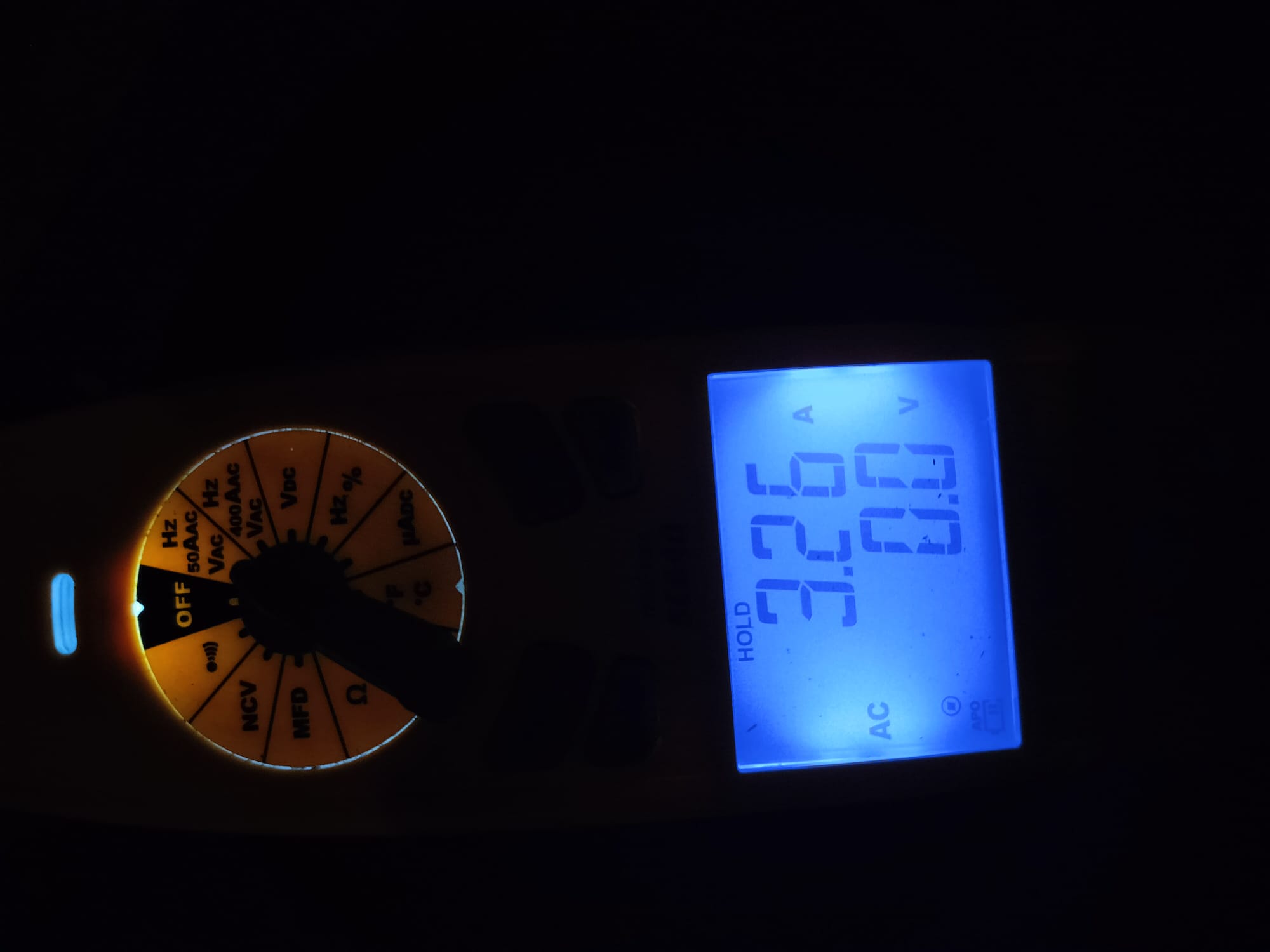 Digital multimeter showing voltage and current readings
