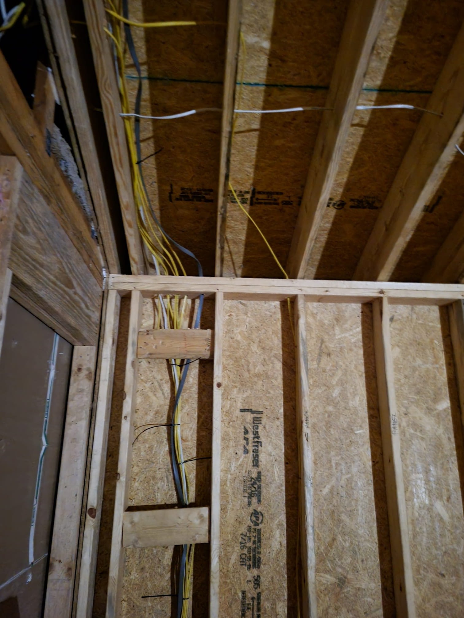 Electrical wiring run through framing before insulation