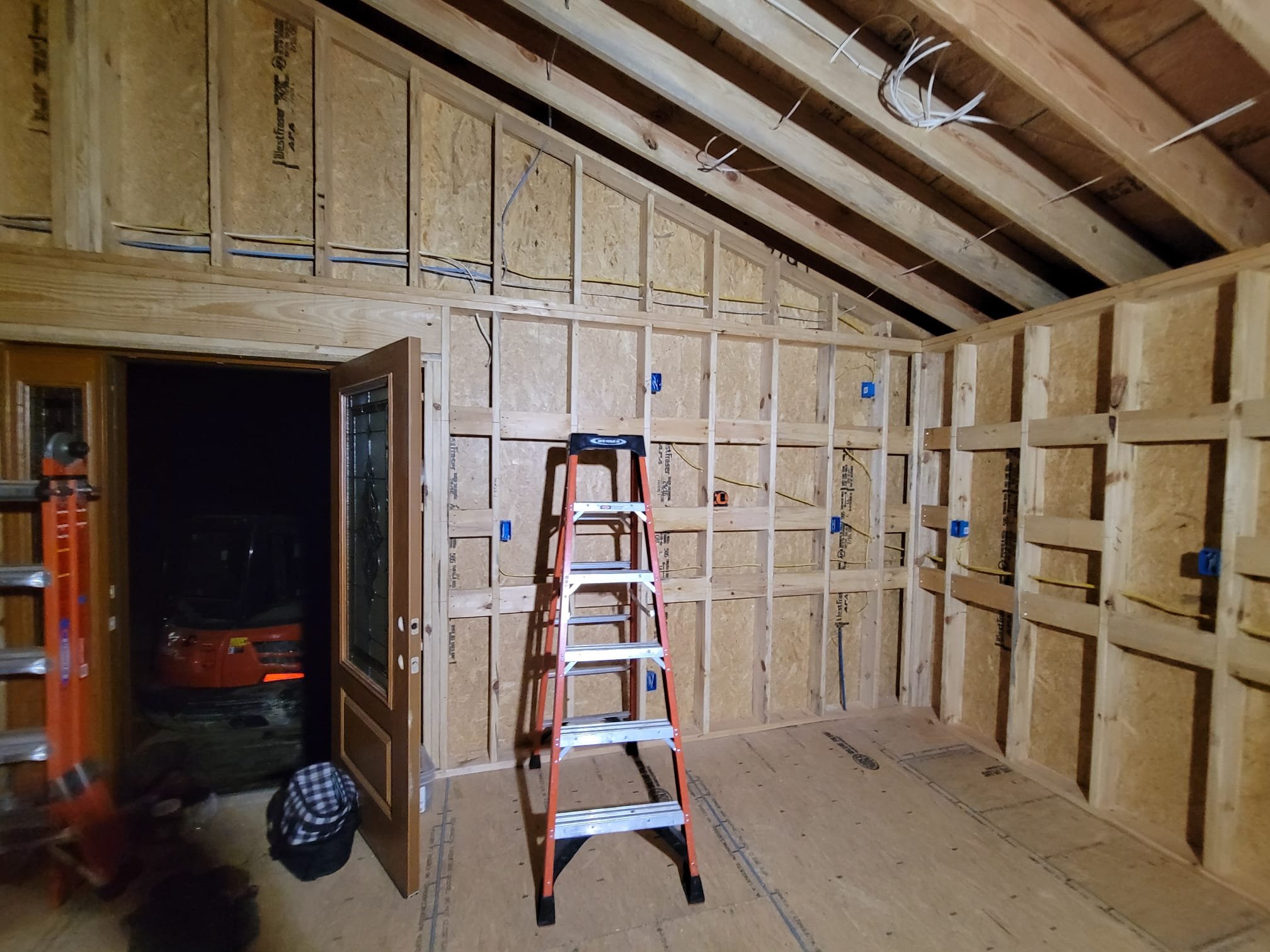 Rough-in stage showing wiring and outlet boxes before drywall