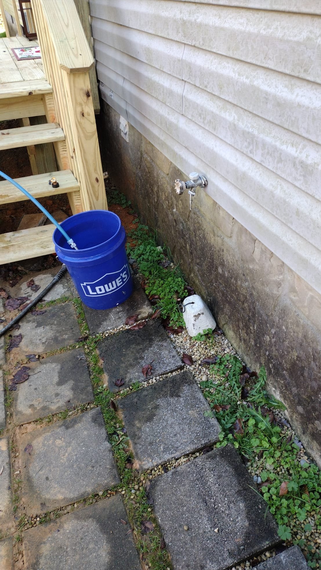 Faucet with garden hose attached during maintenance