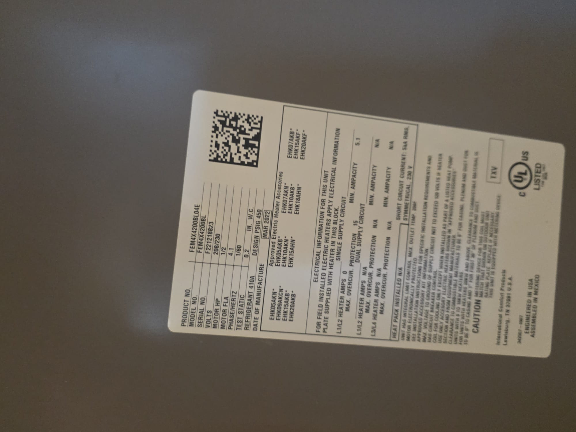 Manufacturer’s label on a new air handler unit showing model and specs