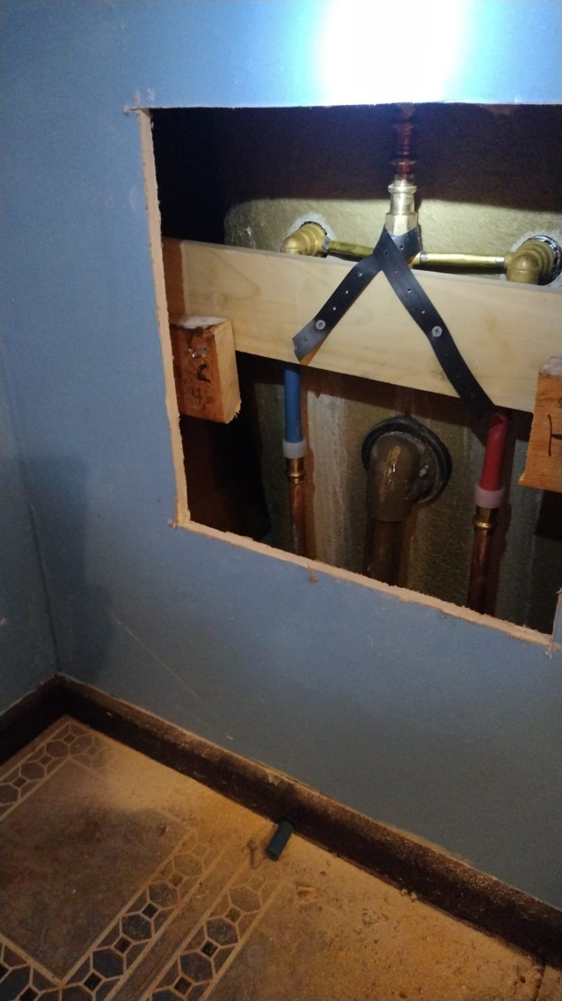 New PEX pipes and fittings secured behind the shower wall