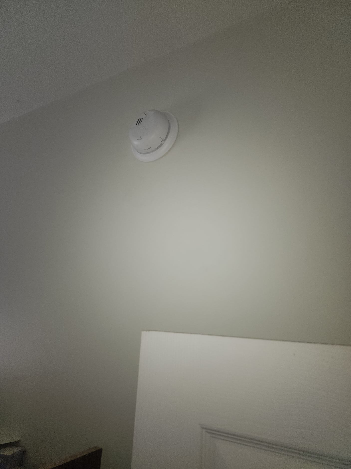 Another newly installed smoke detector, showing clean installation and proper wall placement.