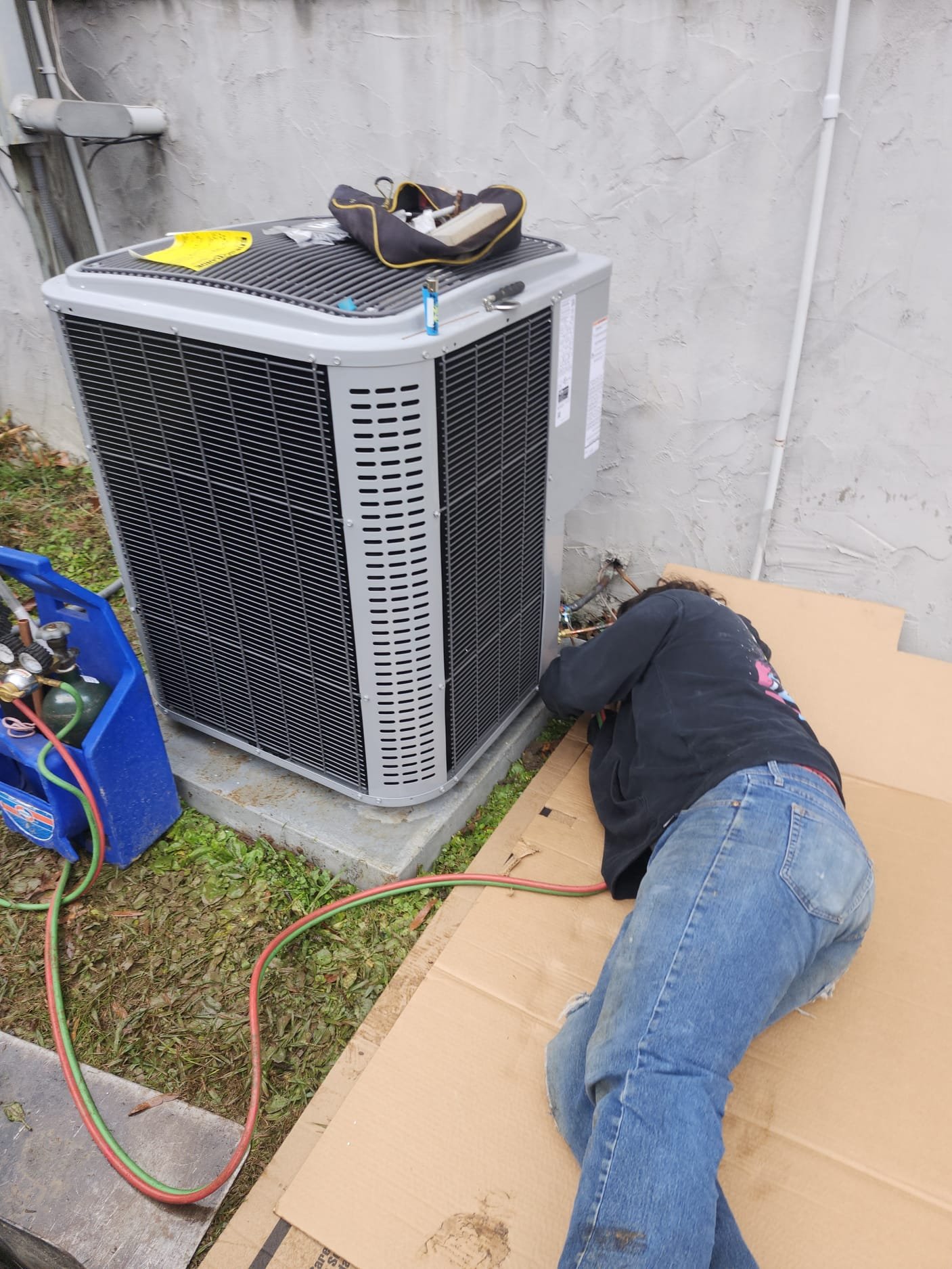 HEP technician at work installing a new heat pump system.