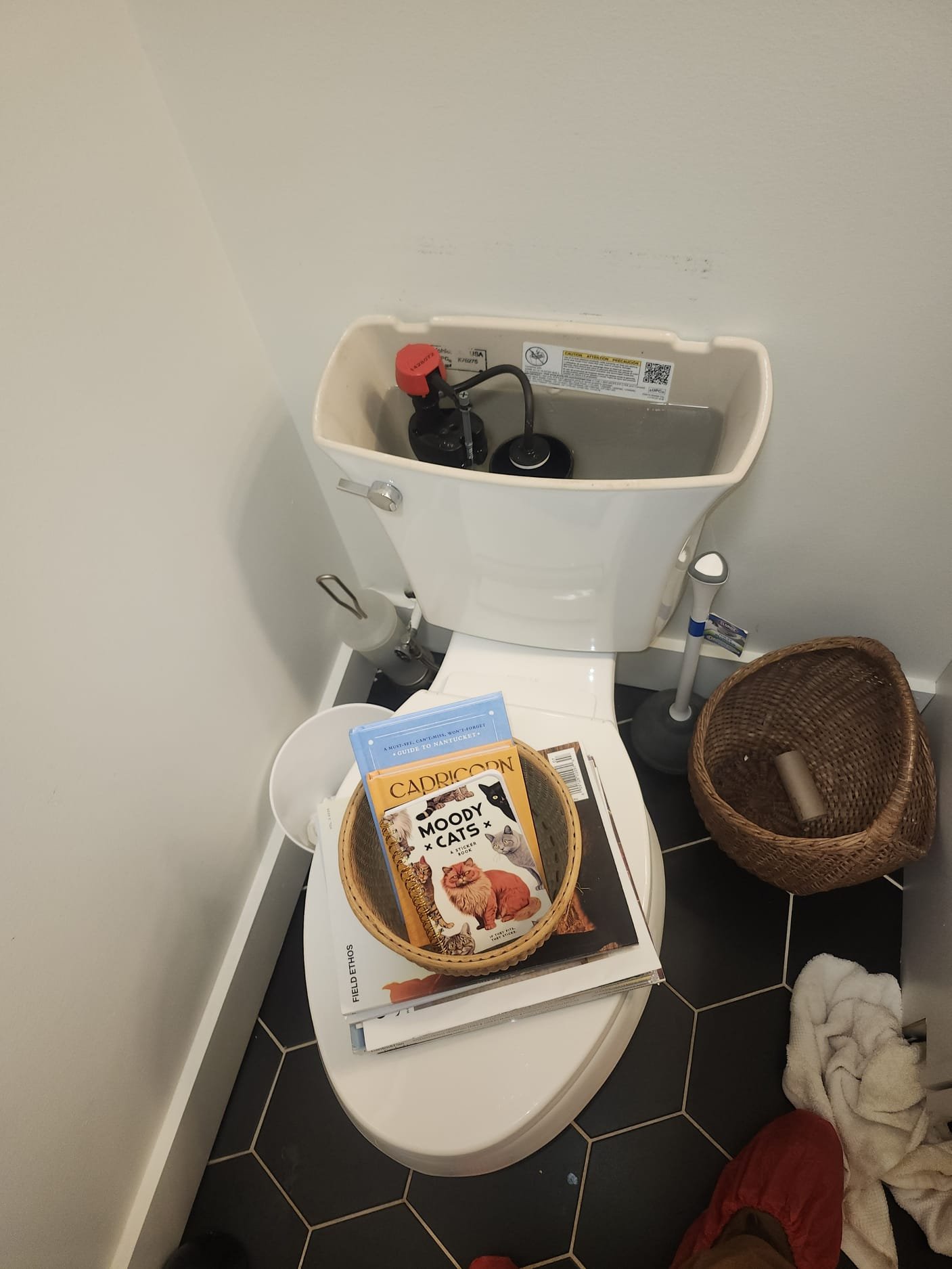 Inside a recently serviced toilet tank, showing clean, newly installed fill valve components.