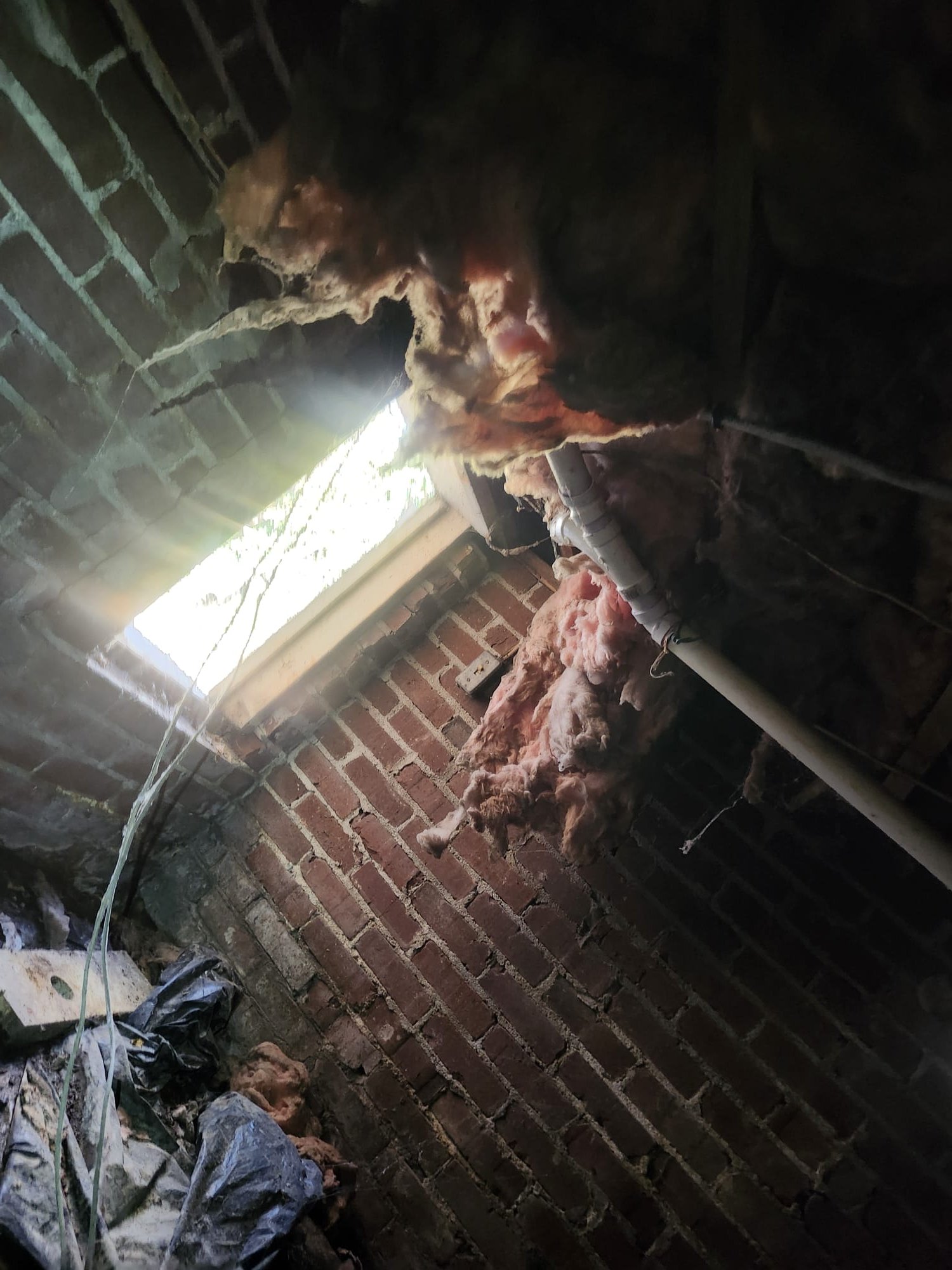 Newly connected PVC drain line in progress.