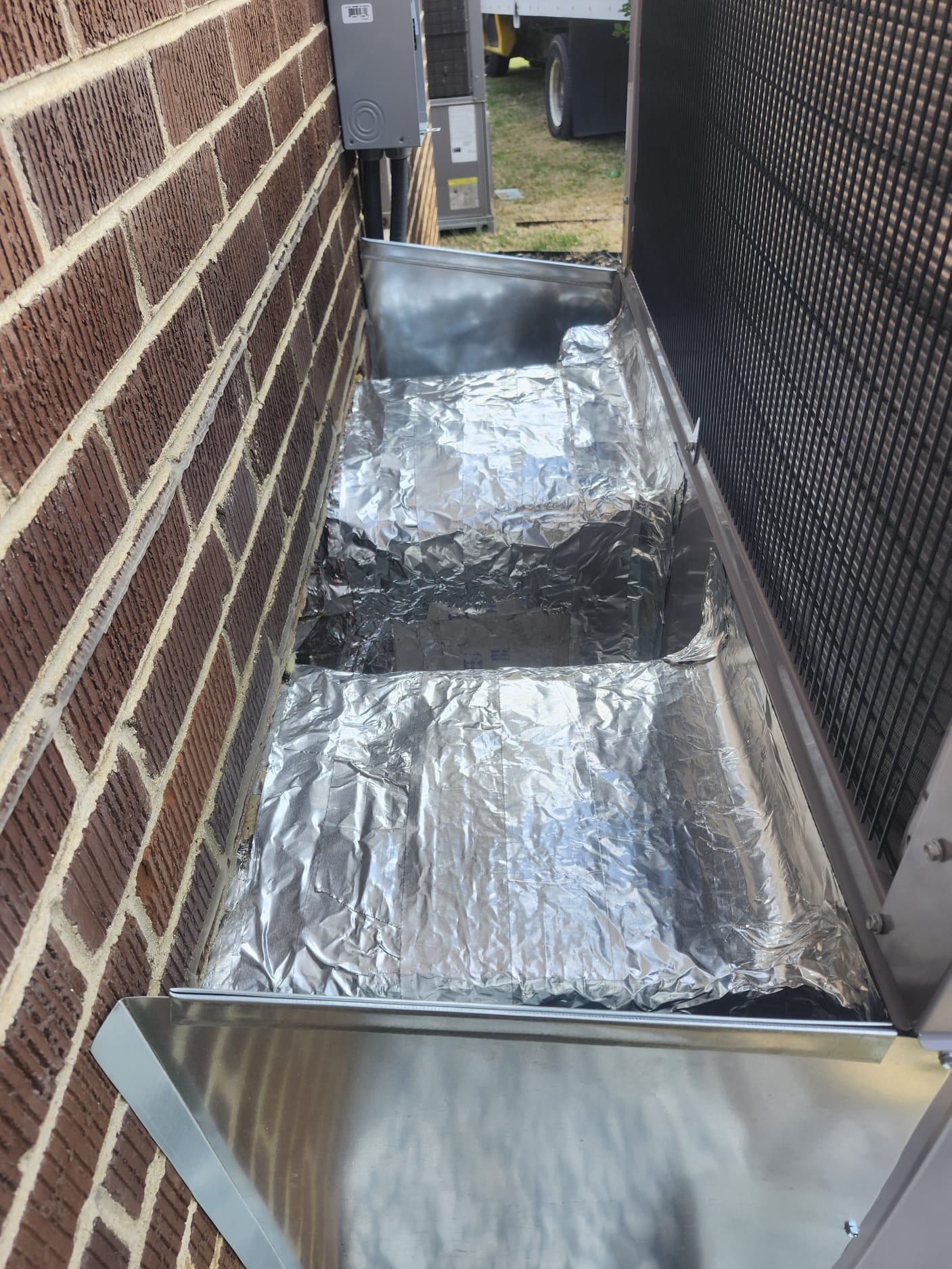 Protective Foil and Pan Installation on Condenser Base