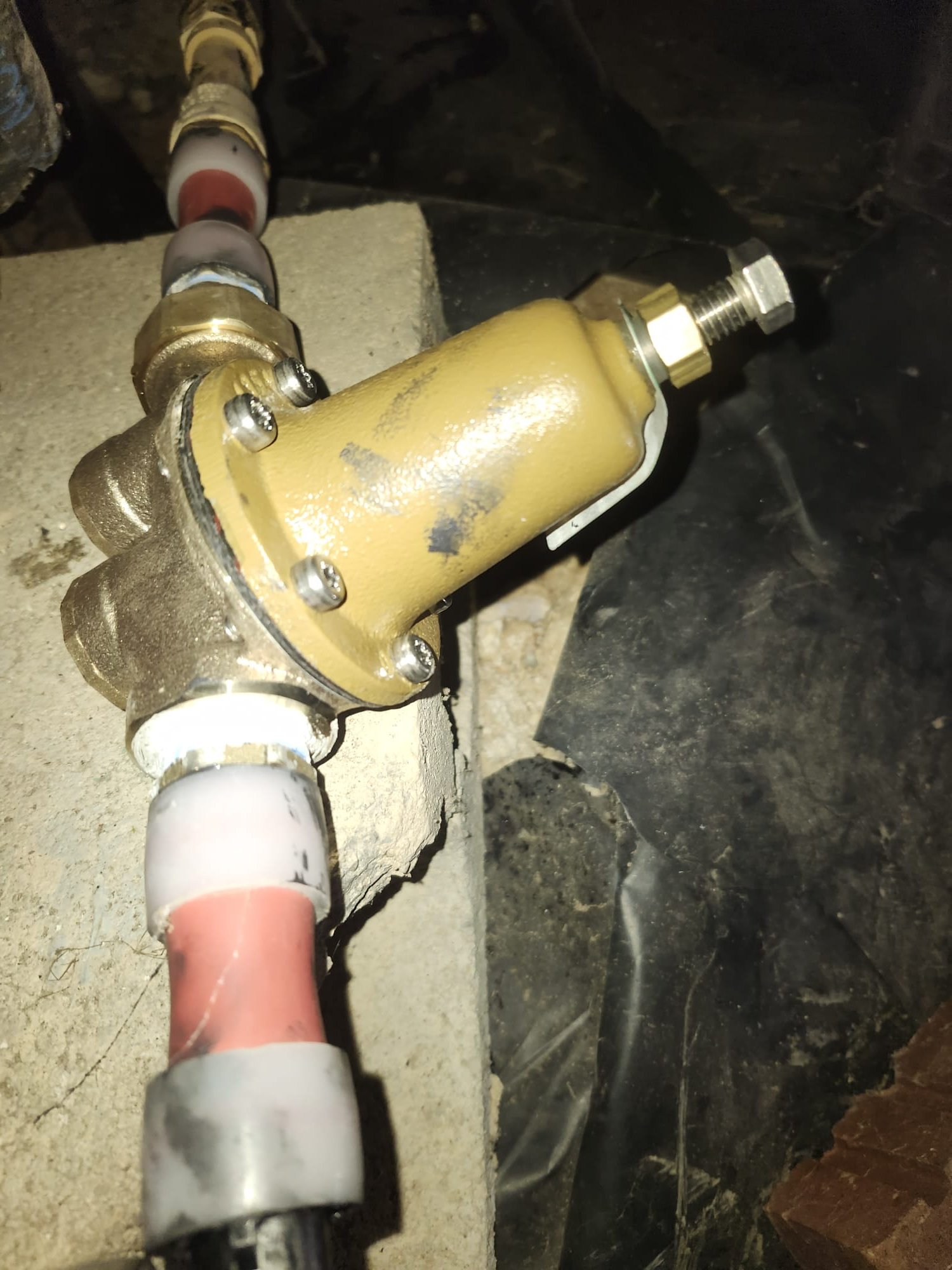 Brass pressure regulator securely connected to PEX piping