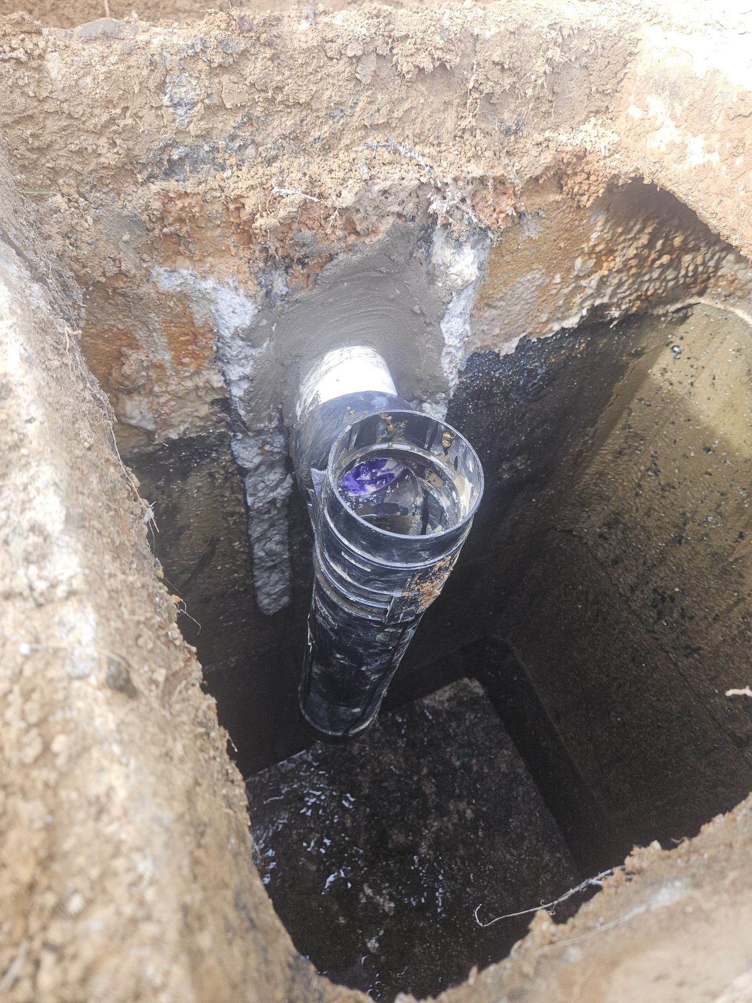 Closeup of primer and cement securing a newly installed PVC joint