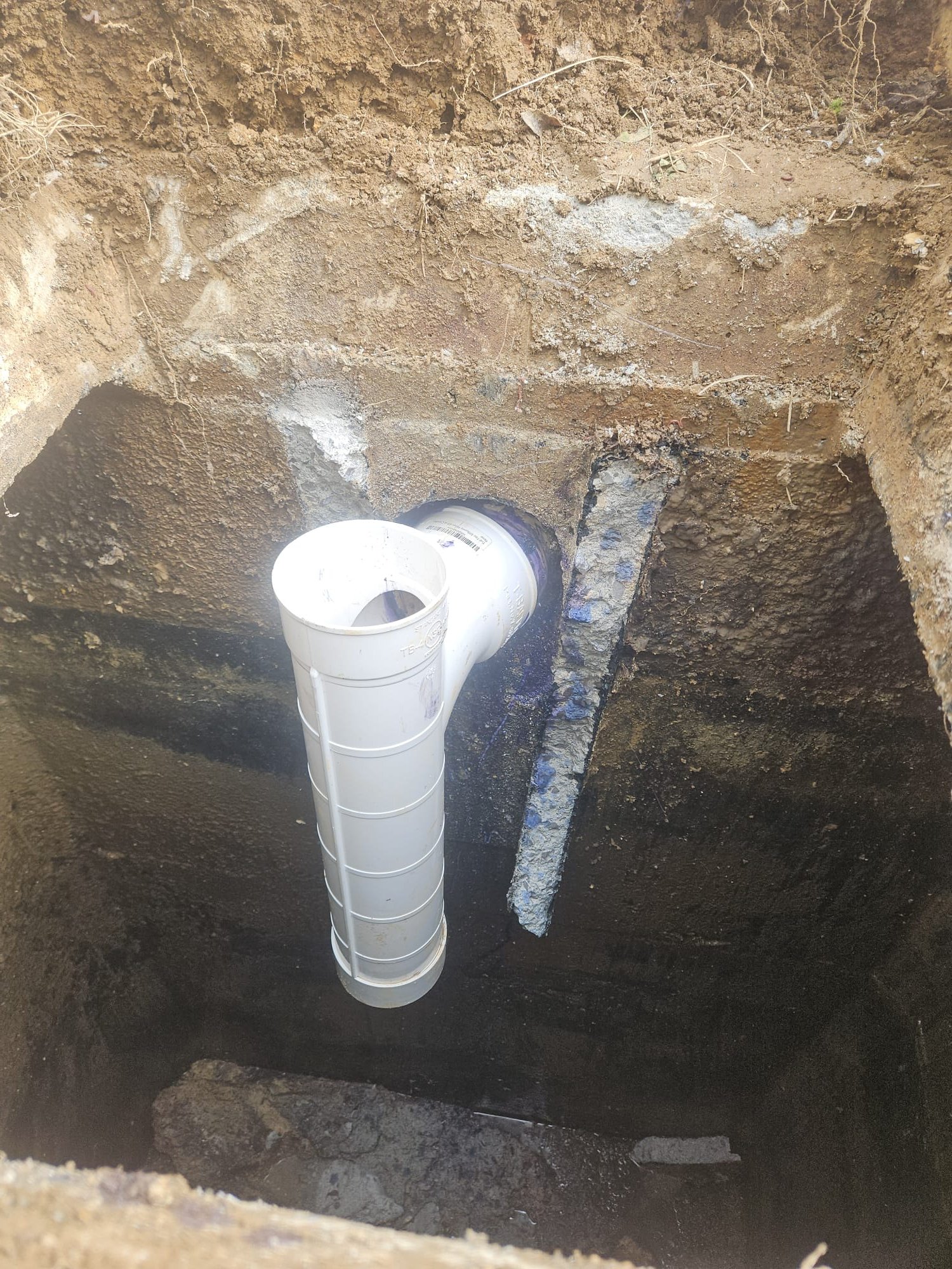 New horizontal cleanout pipe sealed through a concrete wall