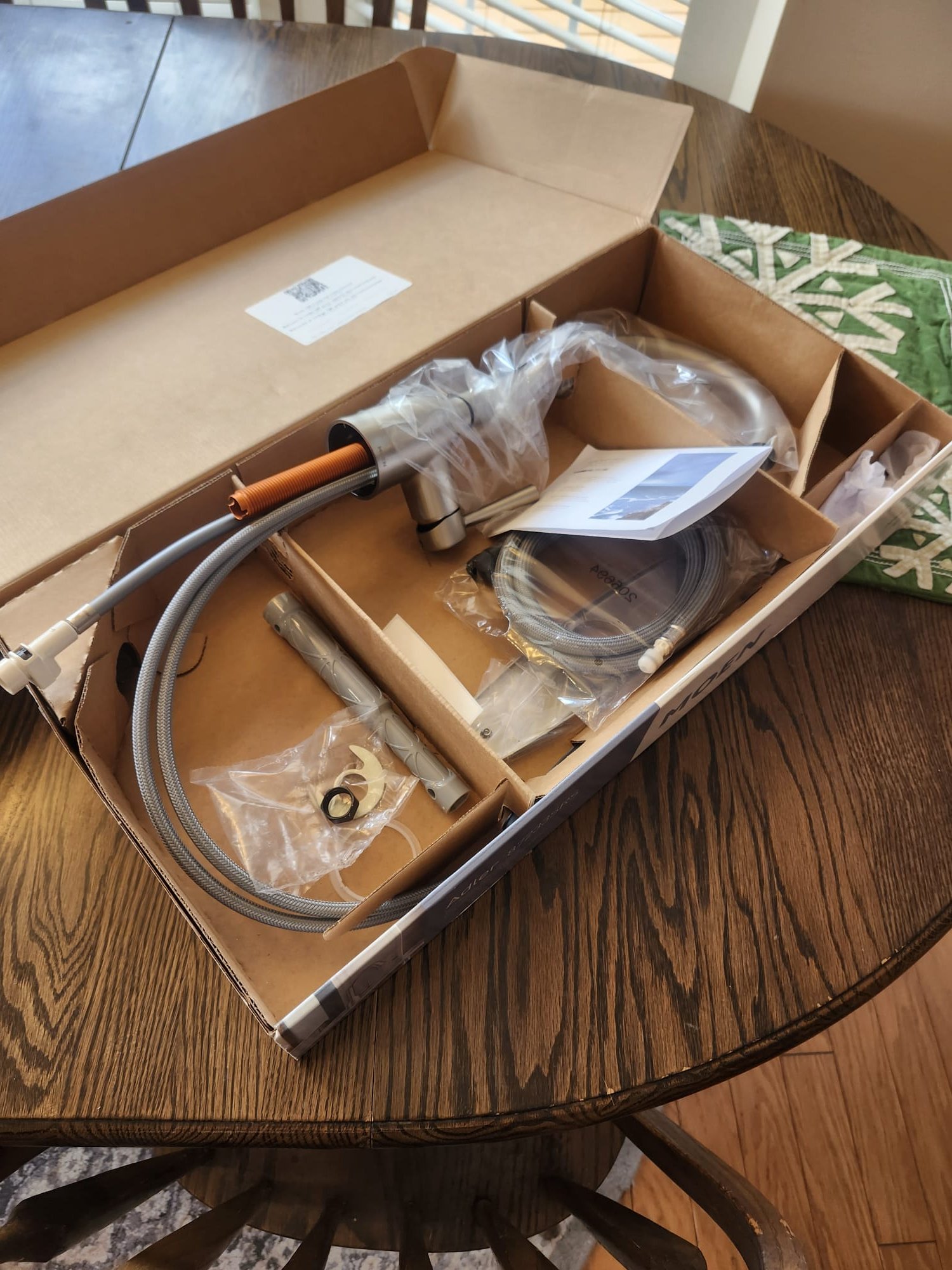 New kitchen faucet parts laid out before installation