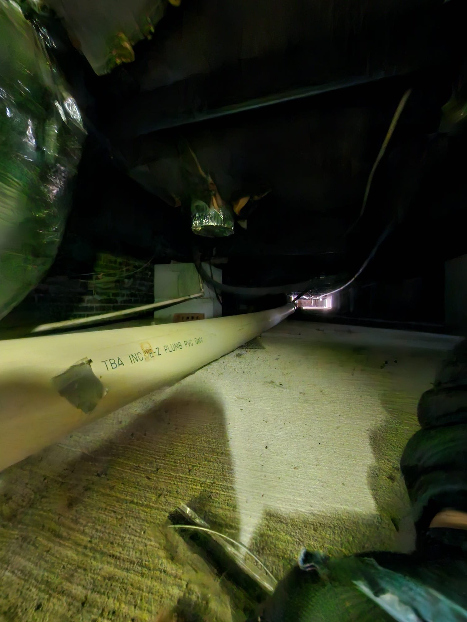 Newly installed PVC plumbing pipe under house