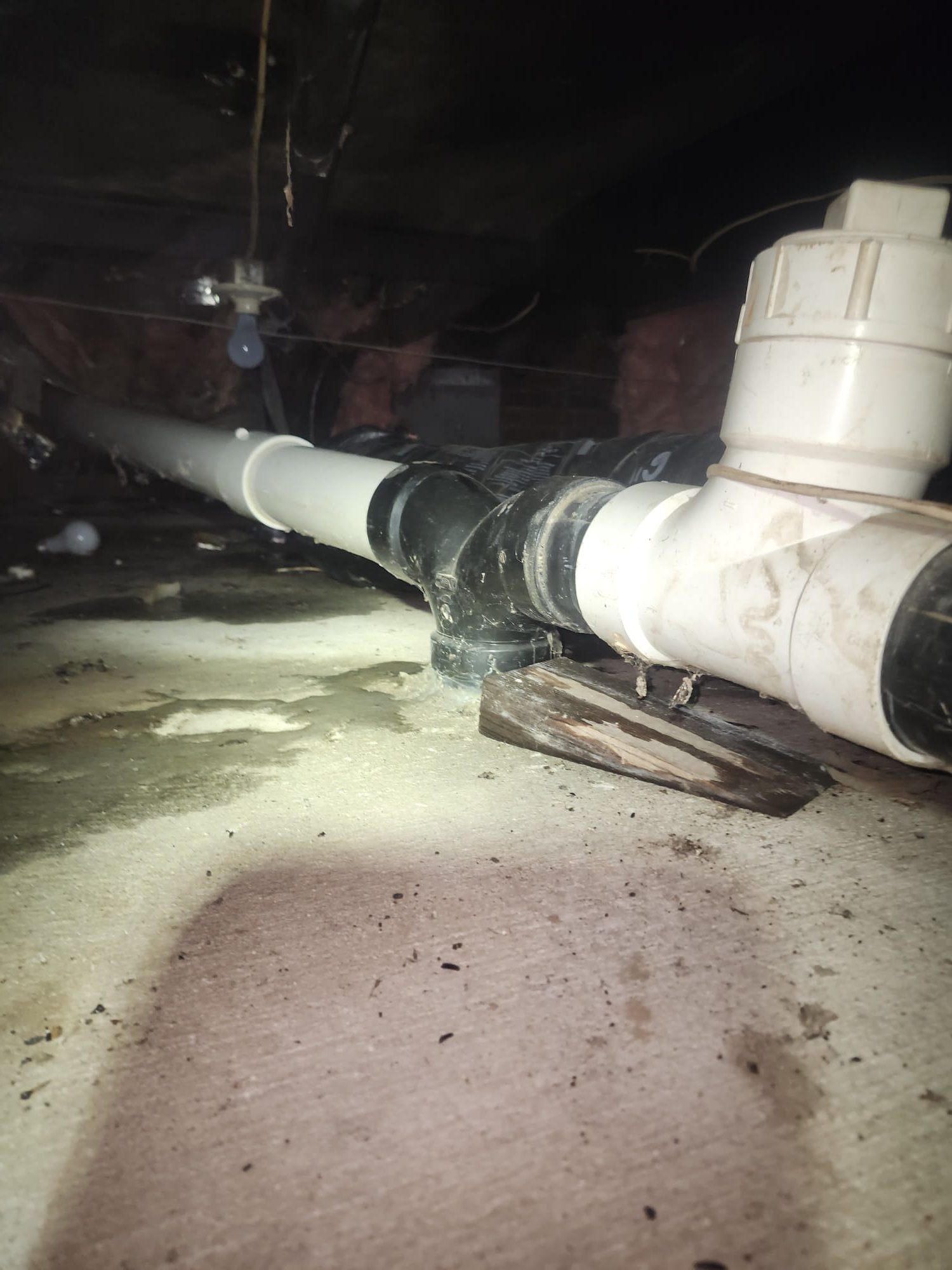 Clean PVC and ABS pipes installed in crawl space
