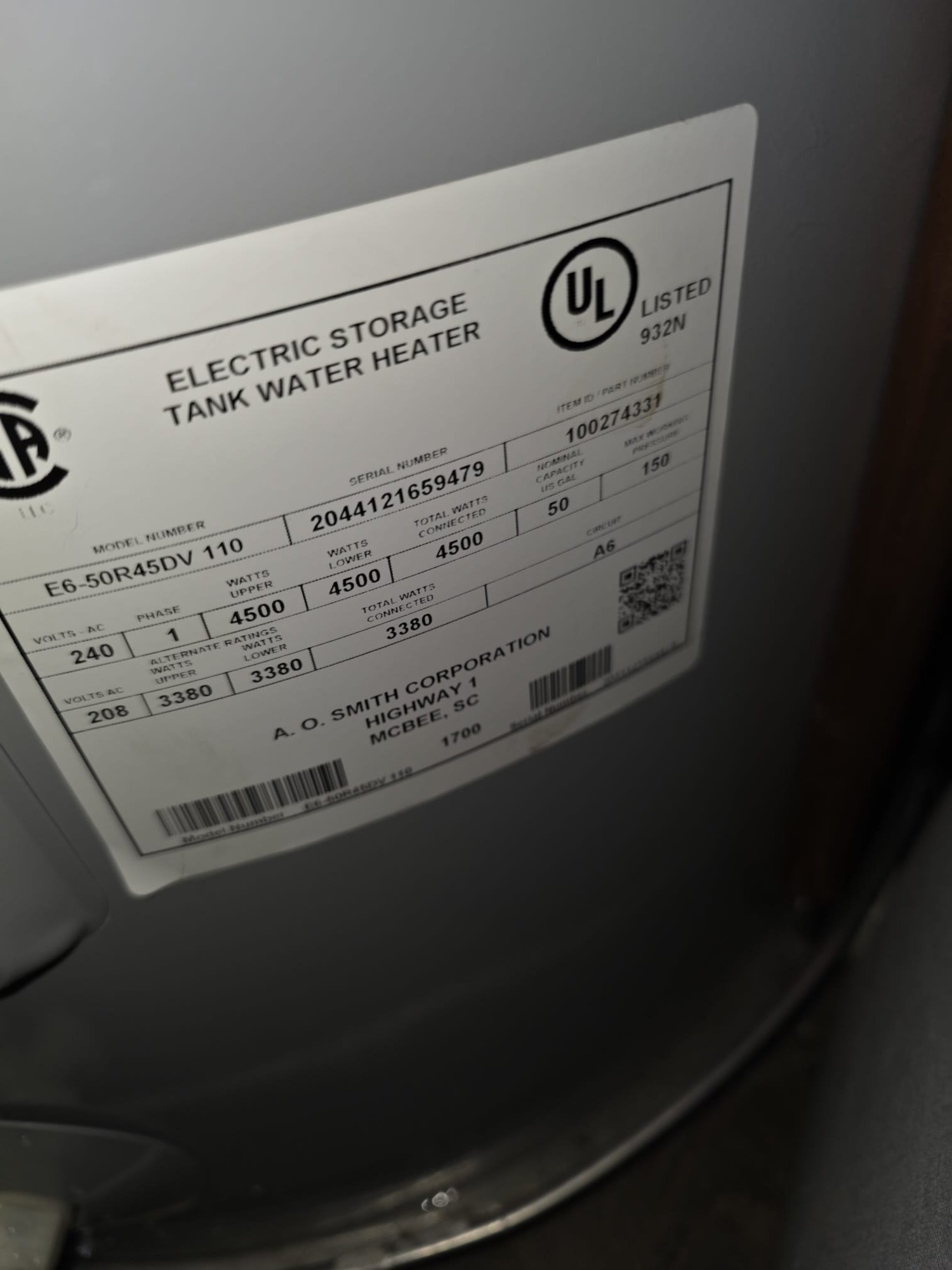 This image shows the label of an electric storage tank water heater, highlighting model, serial, and capacity information.