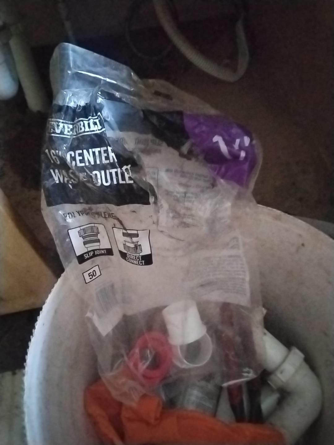 Bucket of plumbing supplies after drain replacement