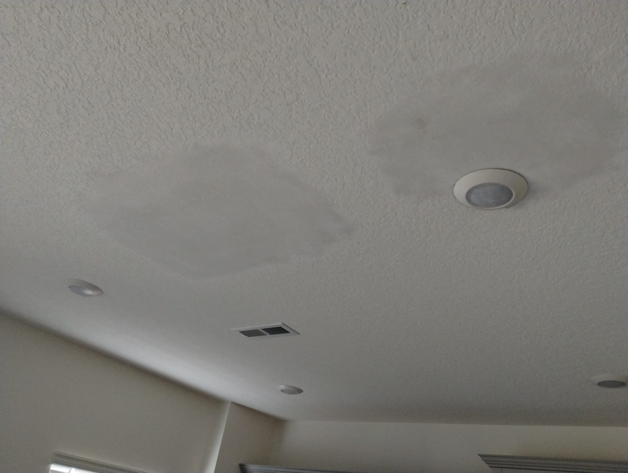 Patched ceiling with fresh drywall patch