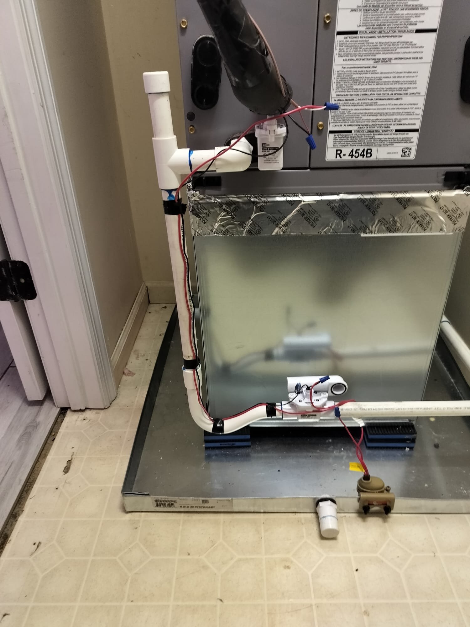 Clean condensate drain pan with float switches and PVC piping