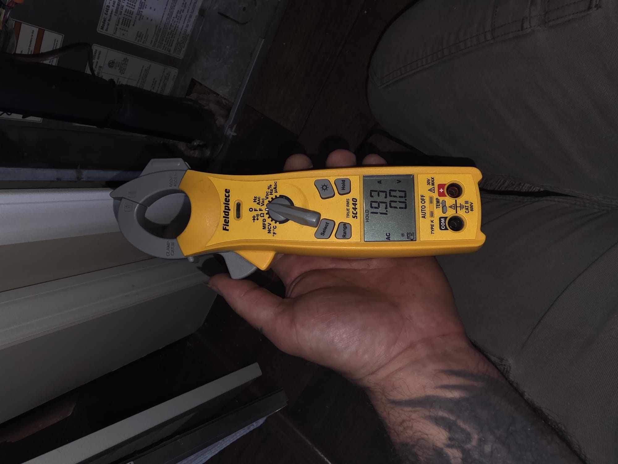 Measuring electrical current with a clamp meter to ensure safe, efficient operation.