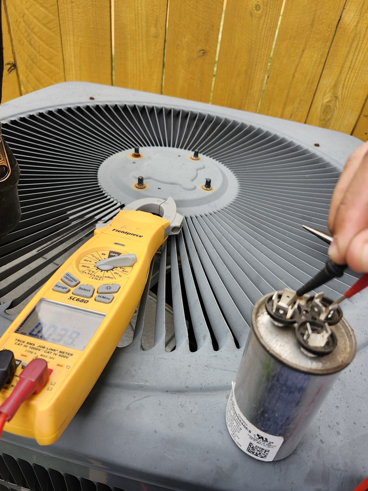 Technician Testing an Outdoor Condenser