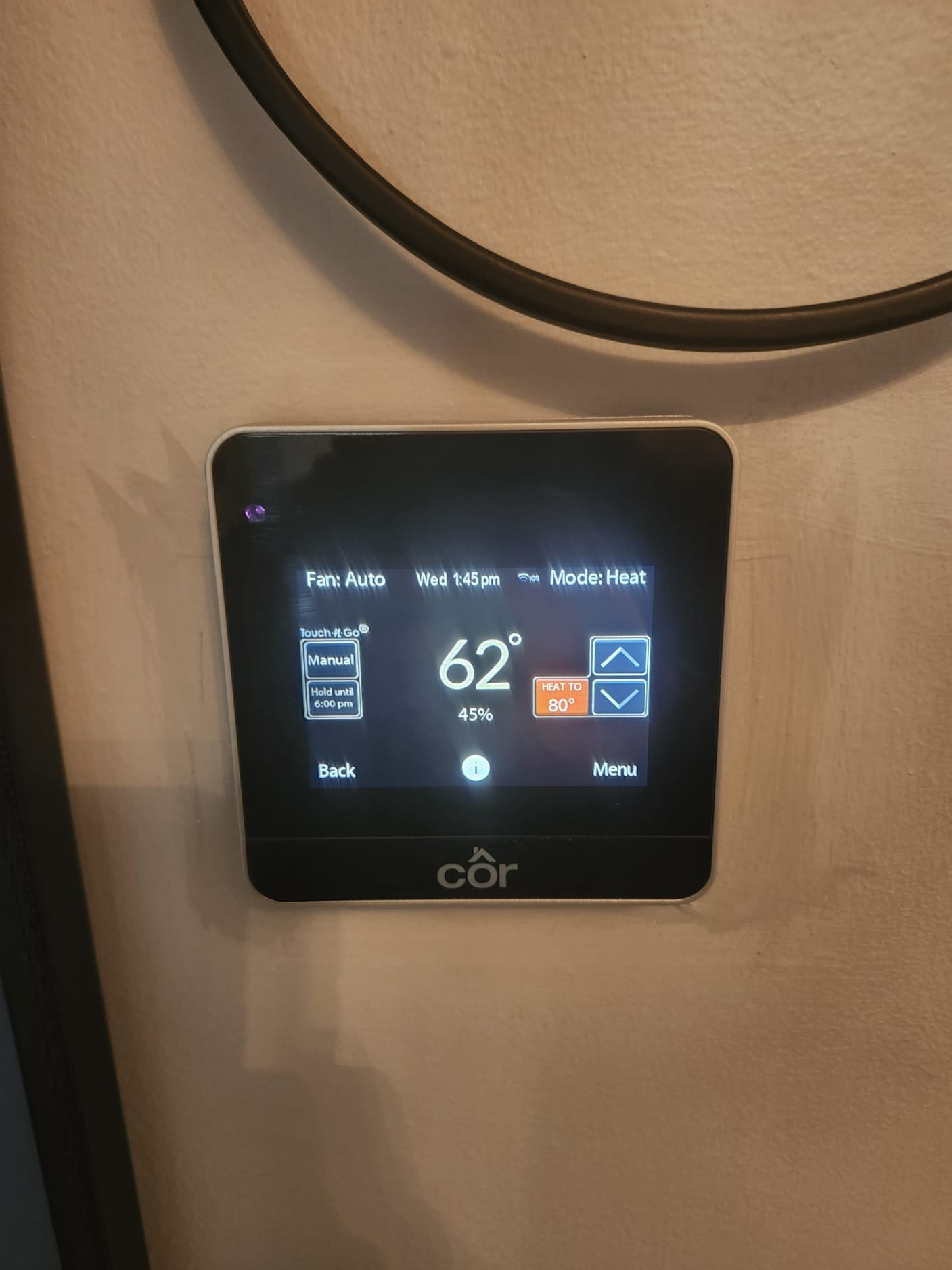 Digital thermostat displaying temperature and mode