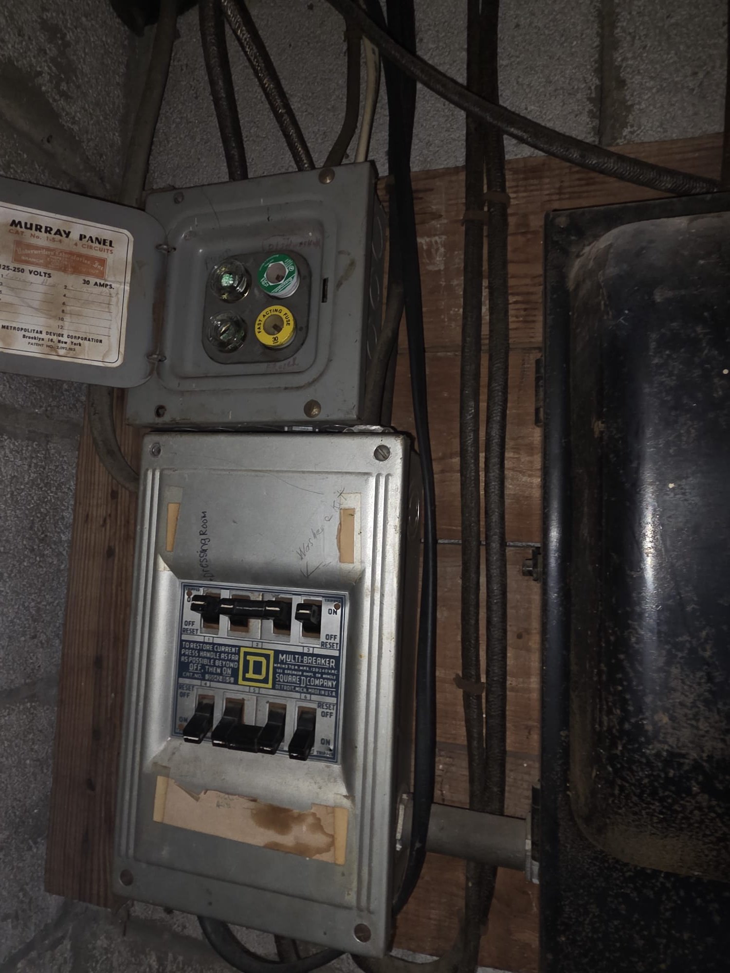 Older style fuse and breaker panel showing outdated equipment