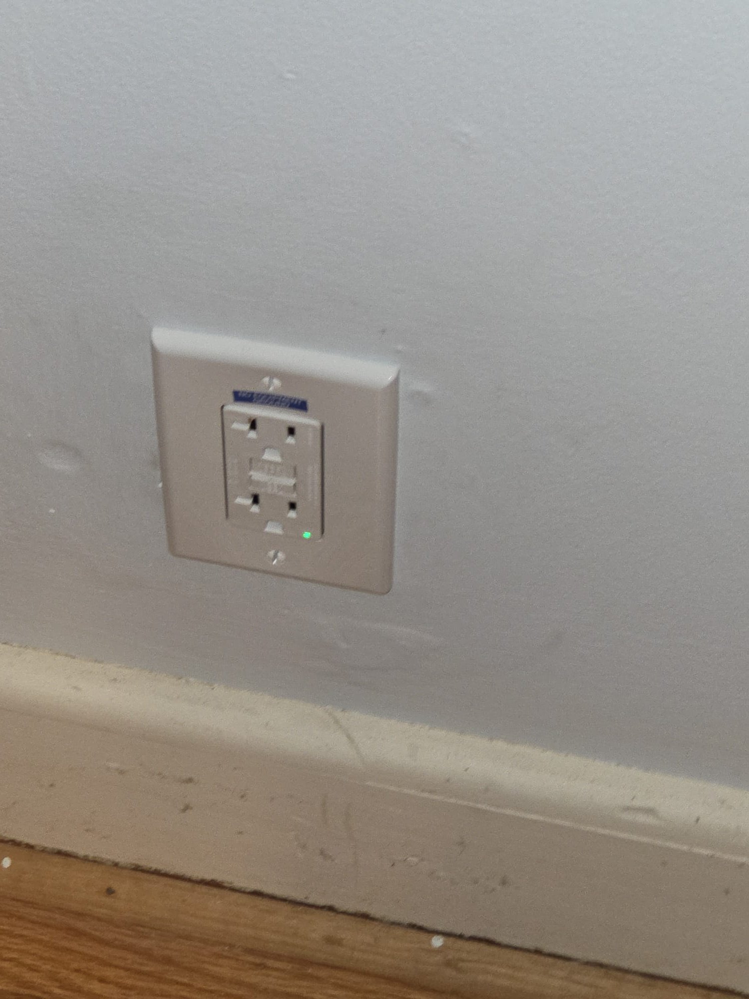 Newly installed GFCI outlet with green power indicator