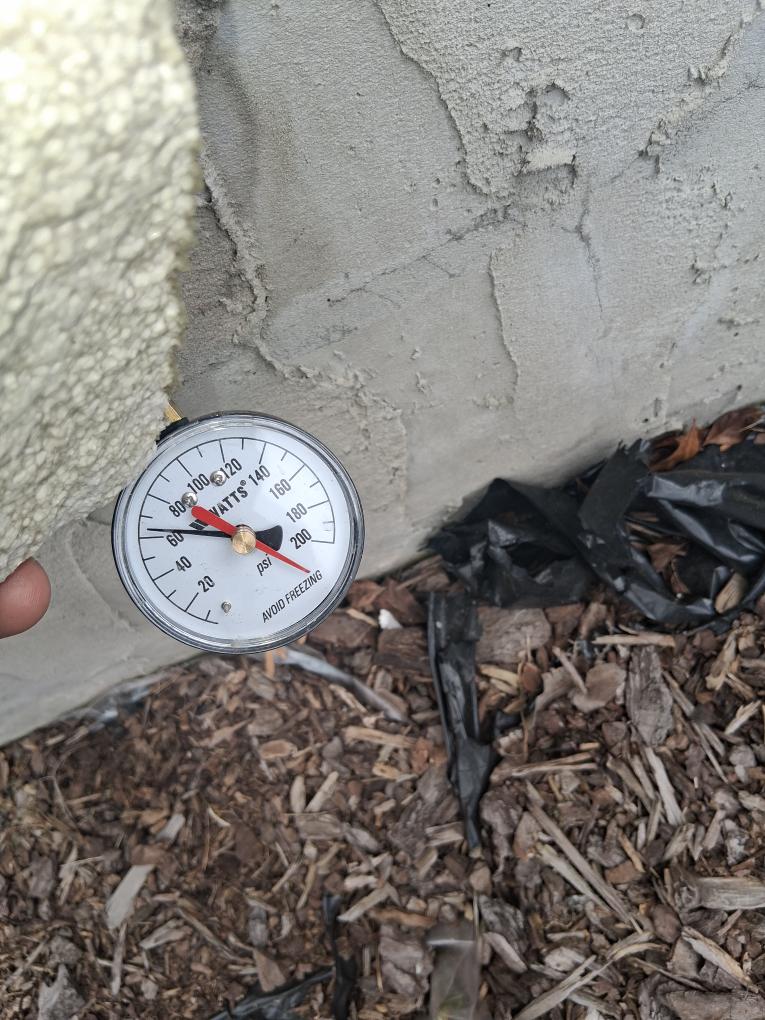 Technician checking water pressure with a gauge