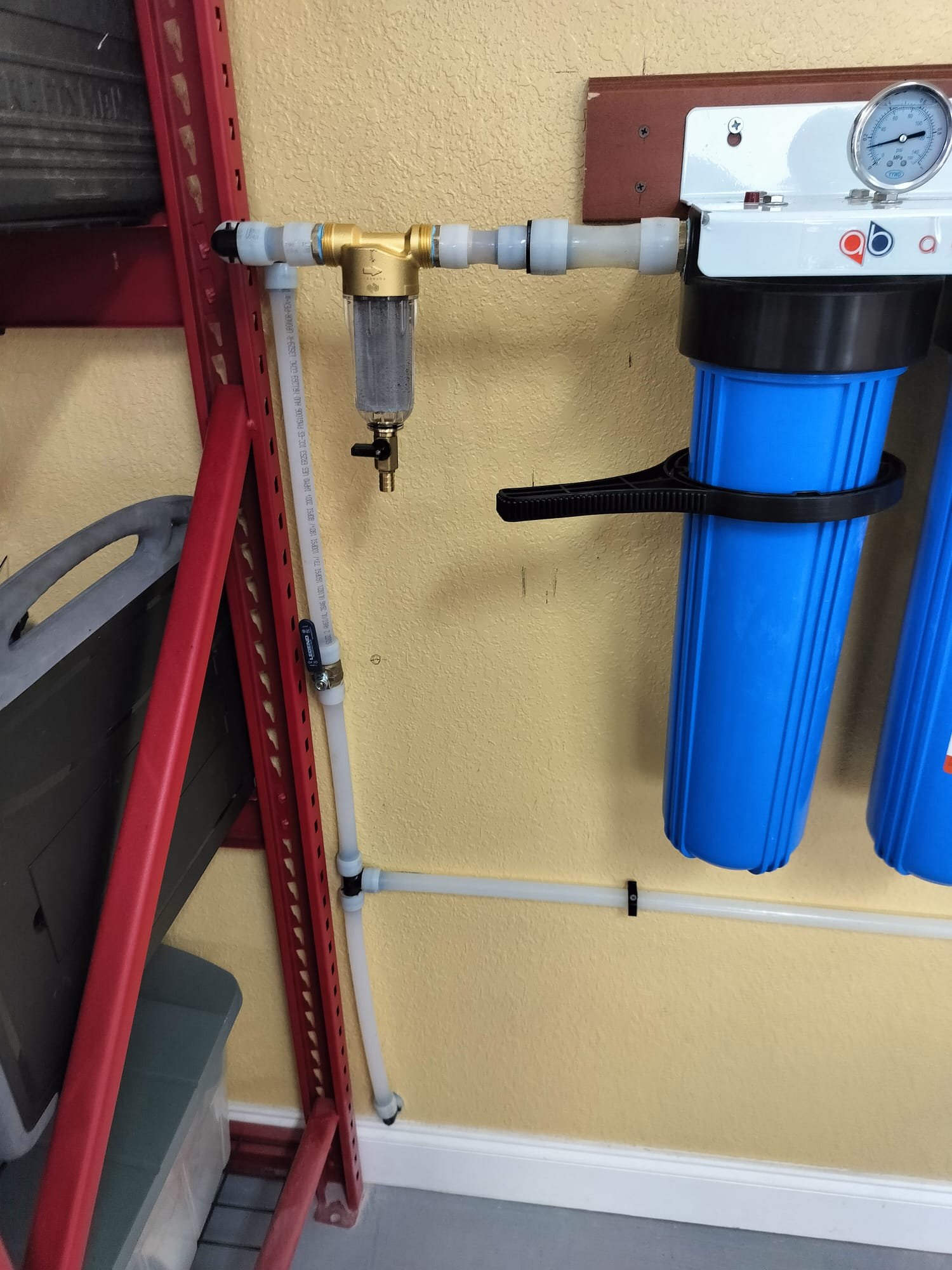 Newly installed brass pre-filter and water filter housing.