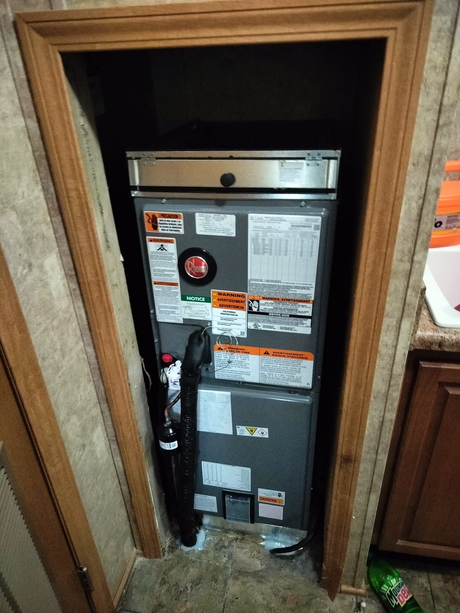 New Rheem indoor air handler neatly installed in a utility closet