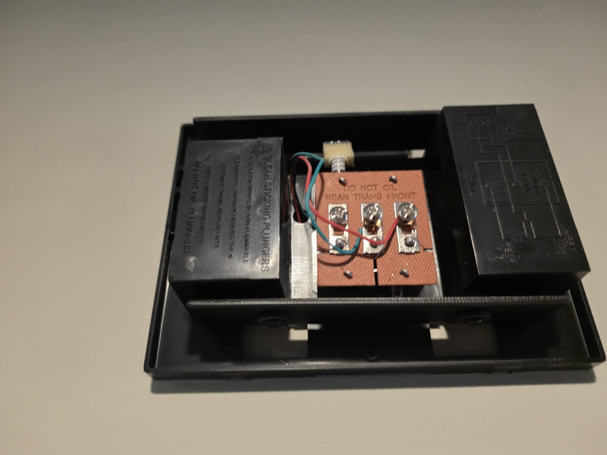 Inside a doorbell chime showing the wiring and terminals.