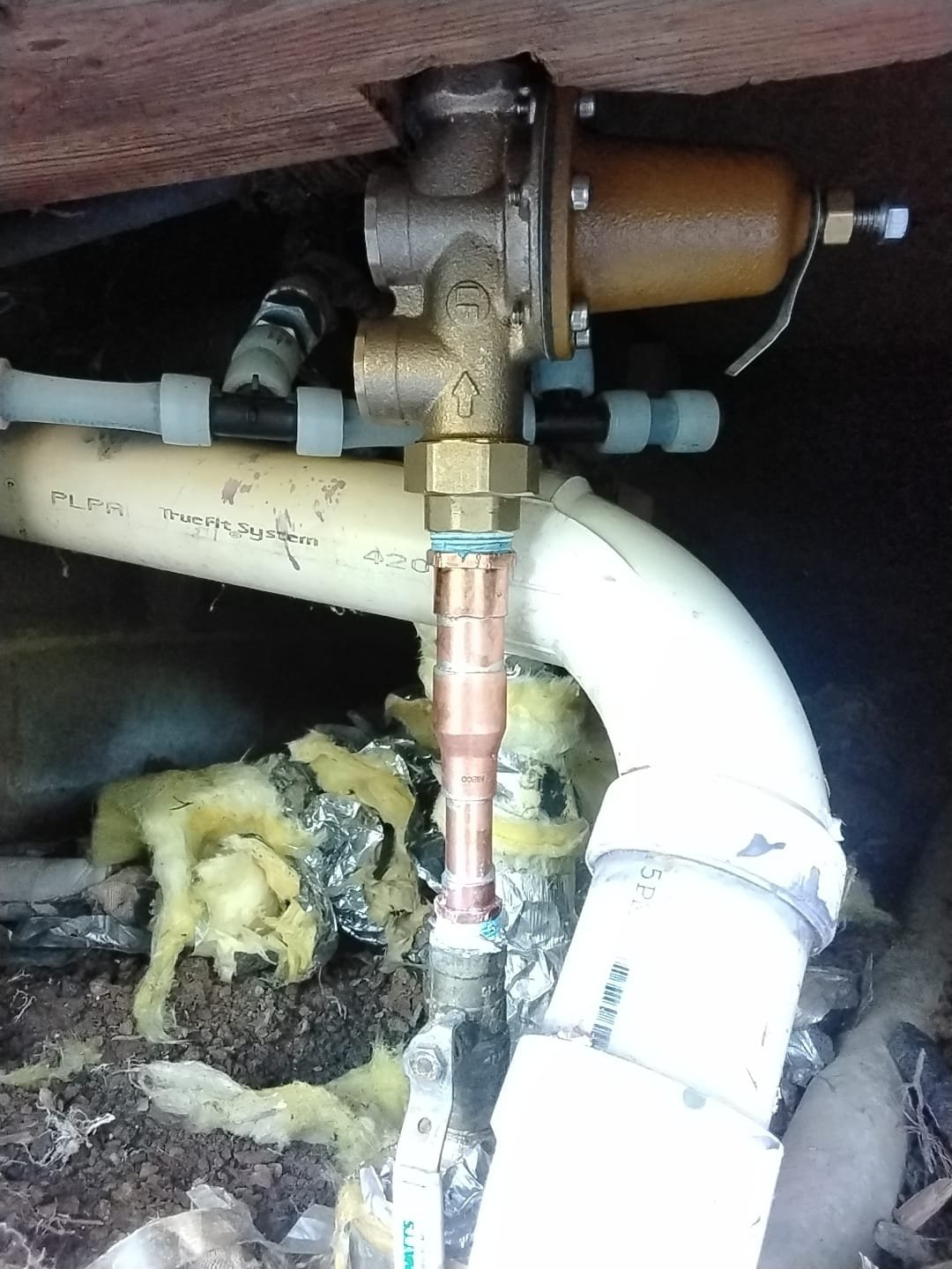 New pressure-regulating valve installed in a crawl space