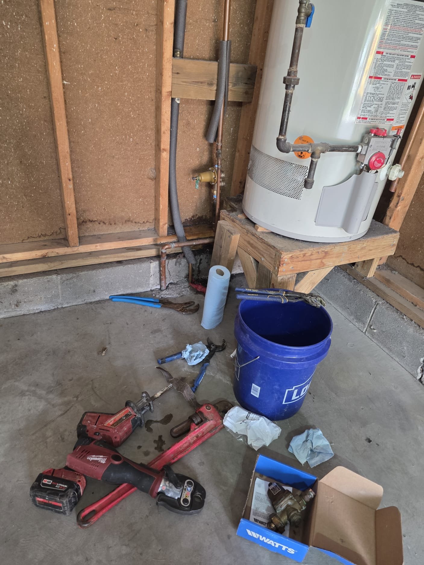 Workspace with new parts and tools for water heater installation