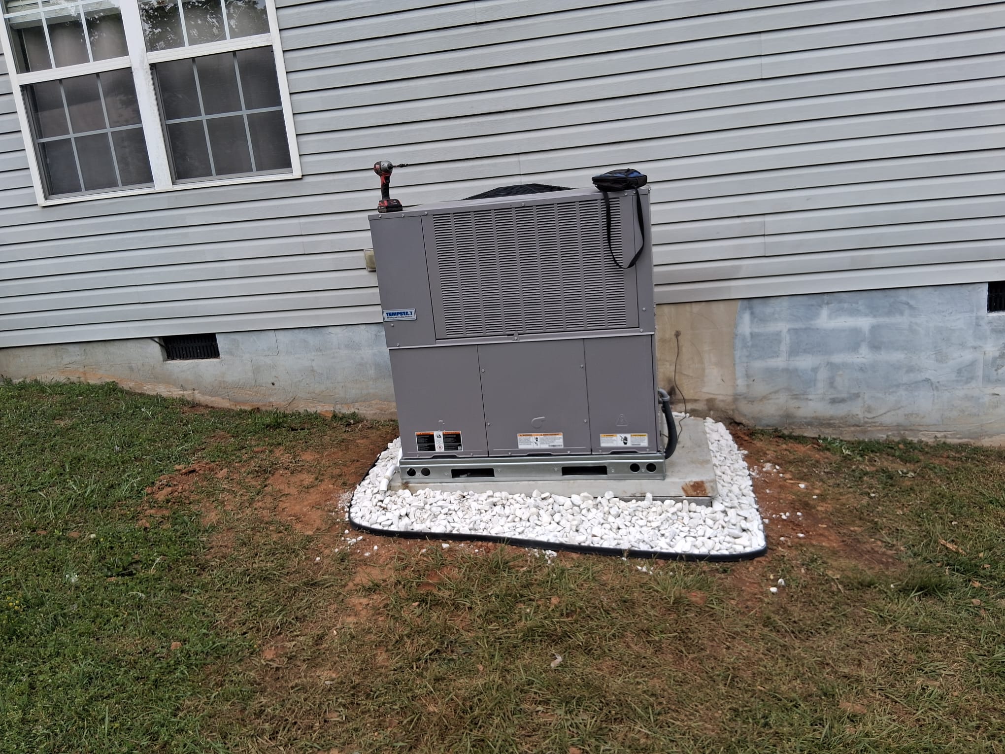 Completed installation on a concrete pad surrounded by gravel