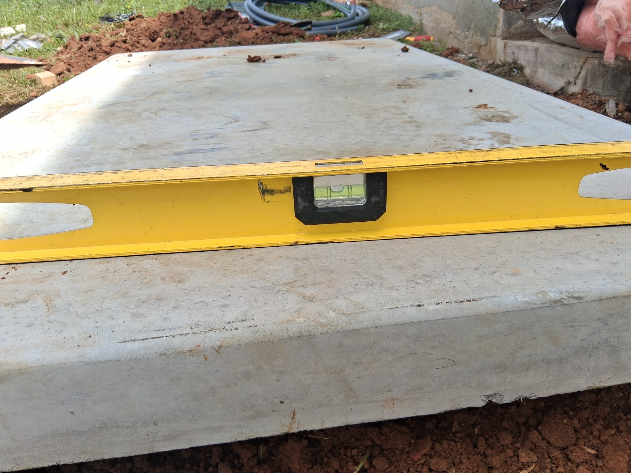 Leveling the concrete pad before installation