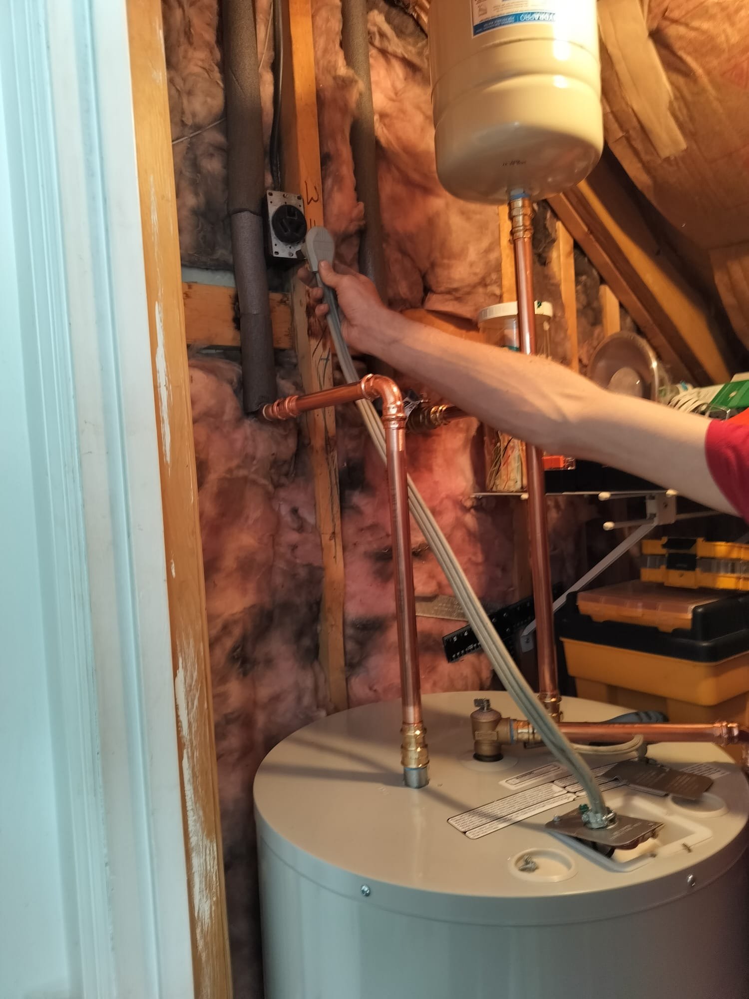 HEP technician making final electrical connections to a new water heater