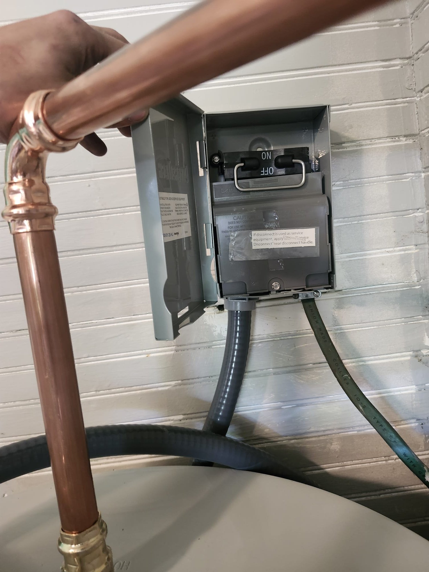Newly installed copper piping and electrical disconnect for water heater