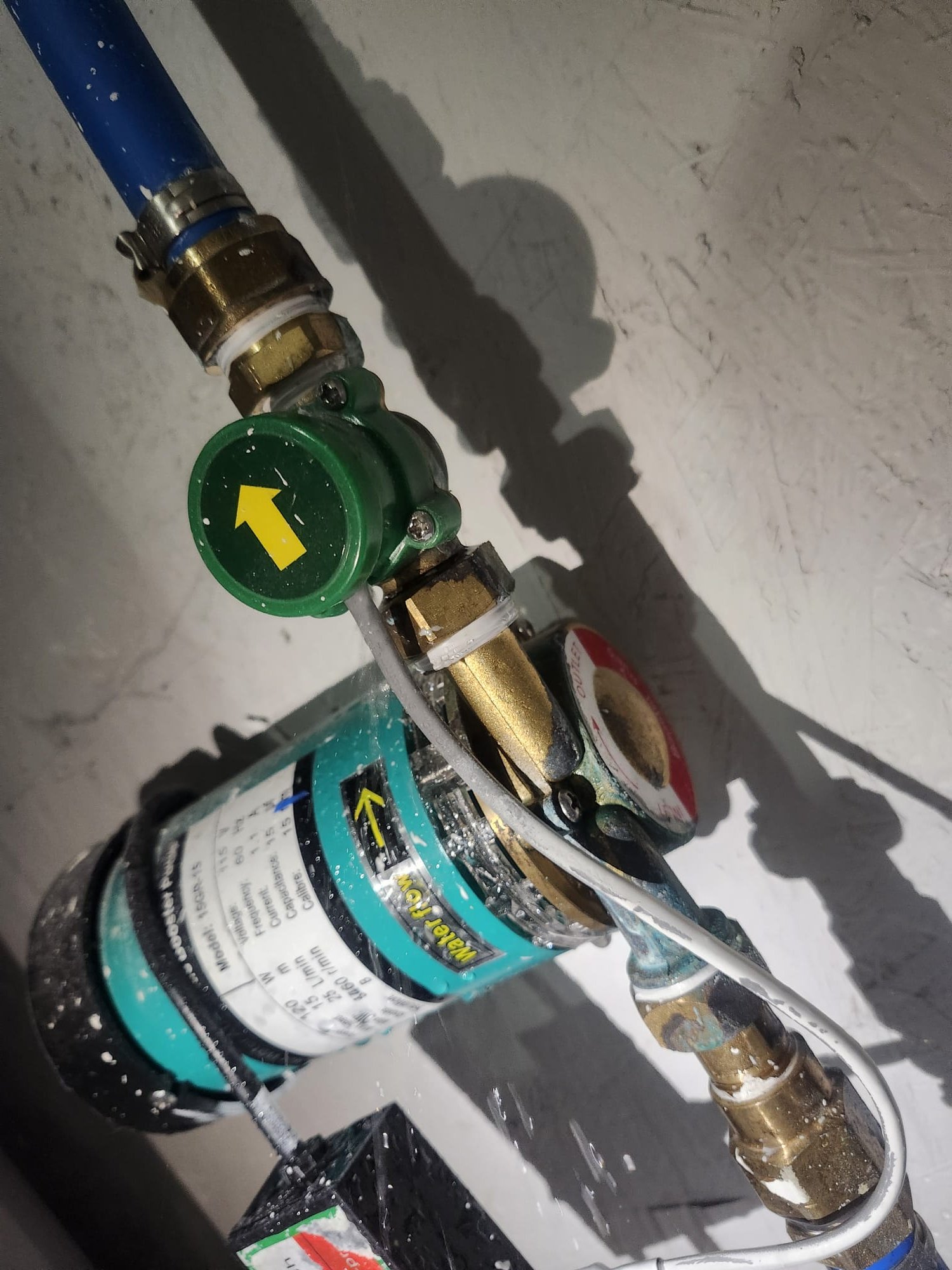 Close-up of a new inline water filter device with clear brass fittings